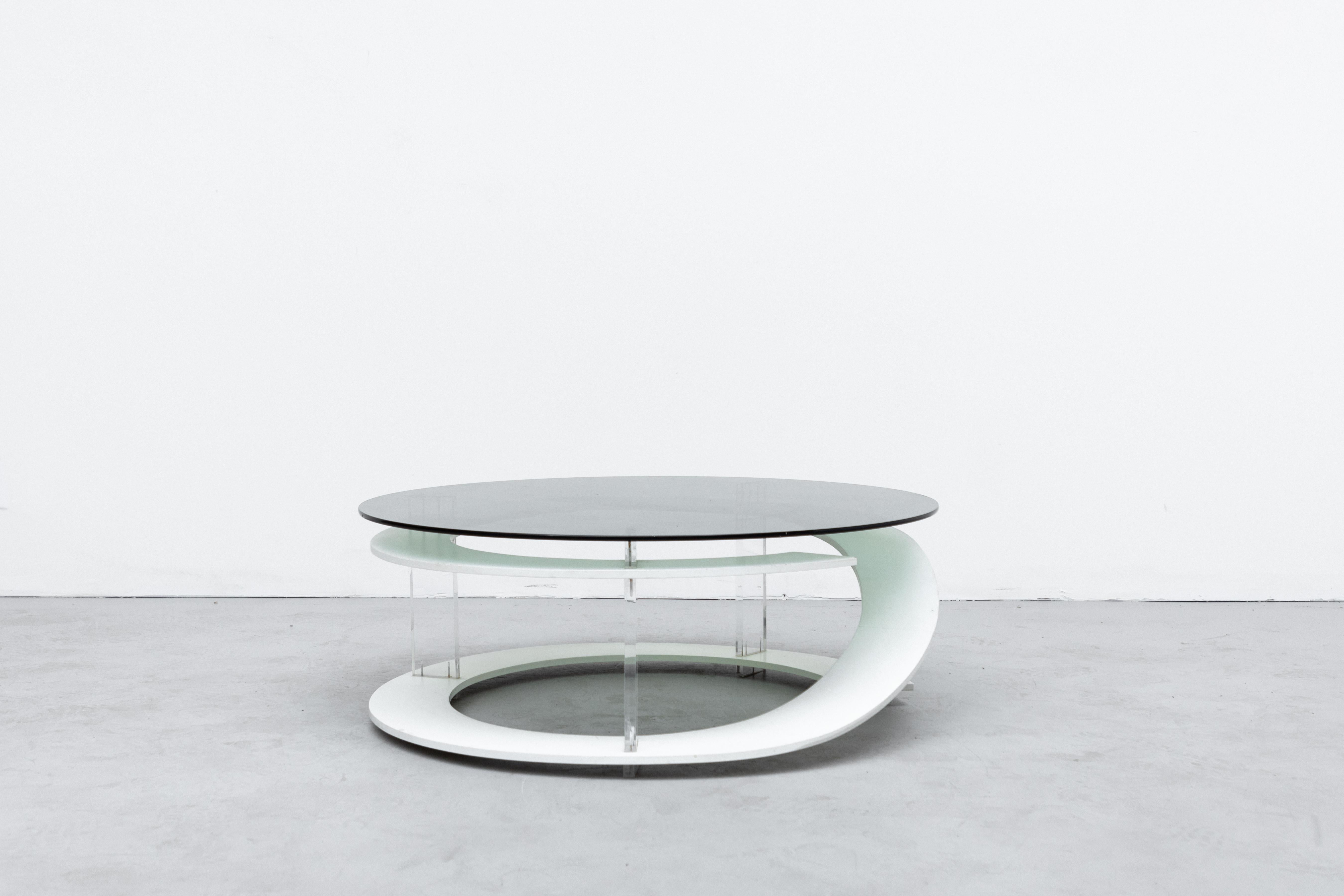 Incredible Space Age Coffee Table with Green Smoked Glass Top and White Stained Wood Spiral with Acrylic Supports. Unique and Stylish Design In Original Condition with Some Visible Scratching to Glass and Frame. Wear is Consistent with Age and Use.