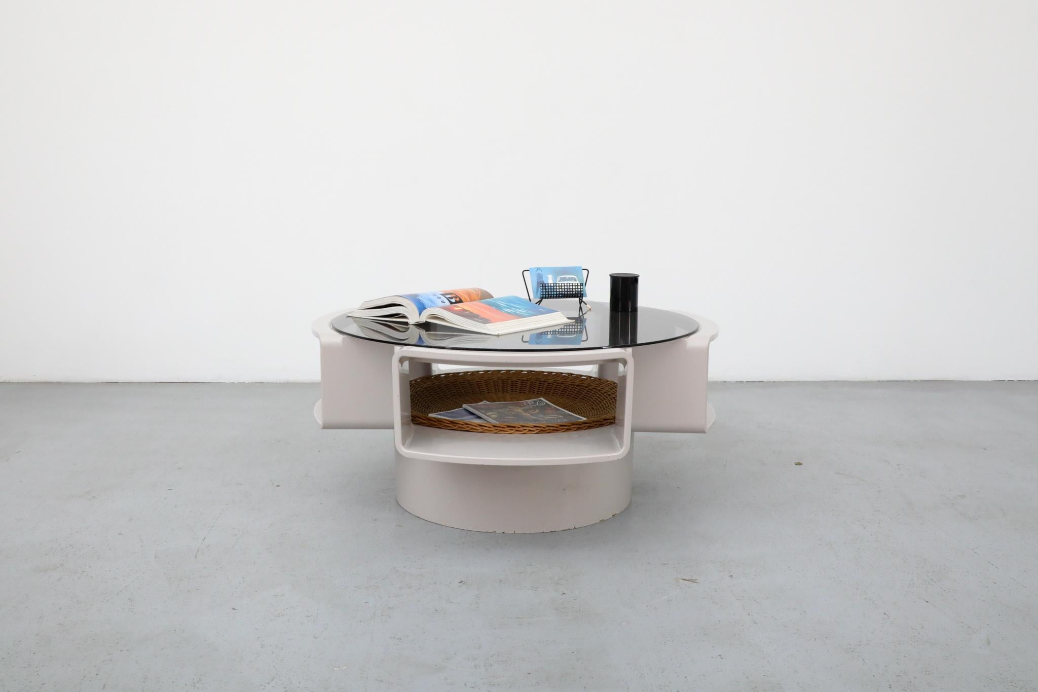 An iconic example of 1970s Dutch Space Age design, this “Orion” coffee table was produced by Curver in 1974. Crafted from molded ABS plastic, the sculptural base features four open compartments that serve both as visual cut-outs and practical