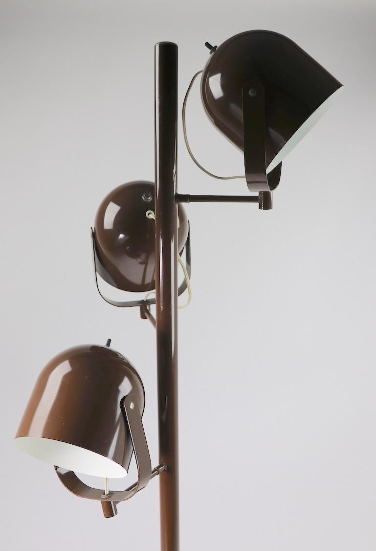 Mod style floor lamp having three independent hood shades ( each hood shade 7 in L x 6 in Dia. ) each shade can be directed to point light and each has its' own on/off switch. Groovy 1970s design, in original chocolate brown paint finish. Designed