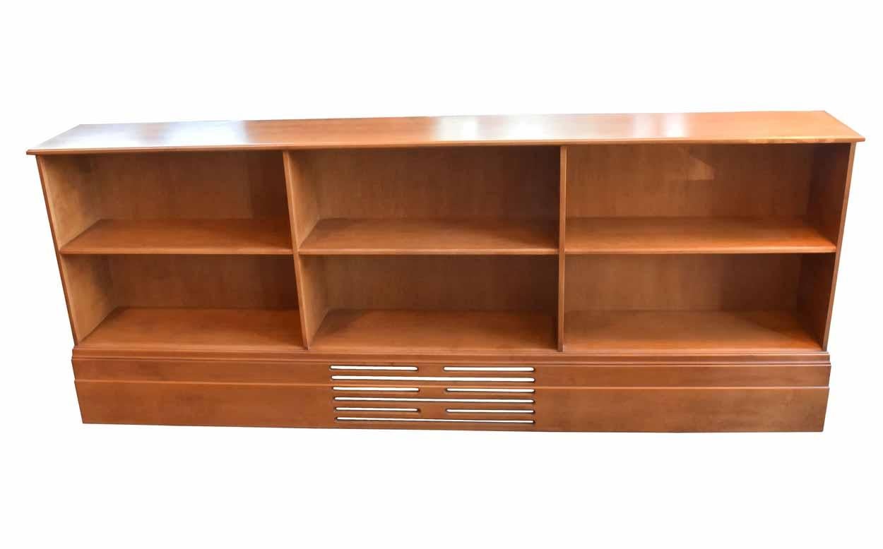 This sleek, solid walnut bookcase is smooth to the touch and in good condition. Decorative fretwork adorns the baseboard, and six spacious compartments will hold your treasured literary collections,

circa 1980.
Condition: Good
Finish: