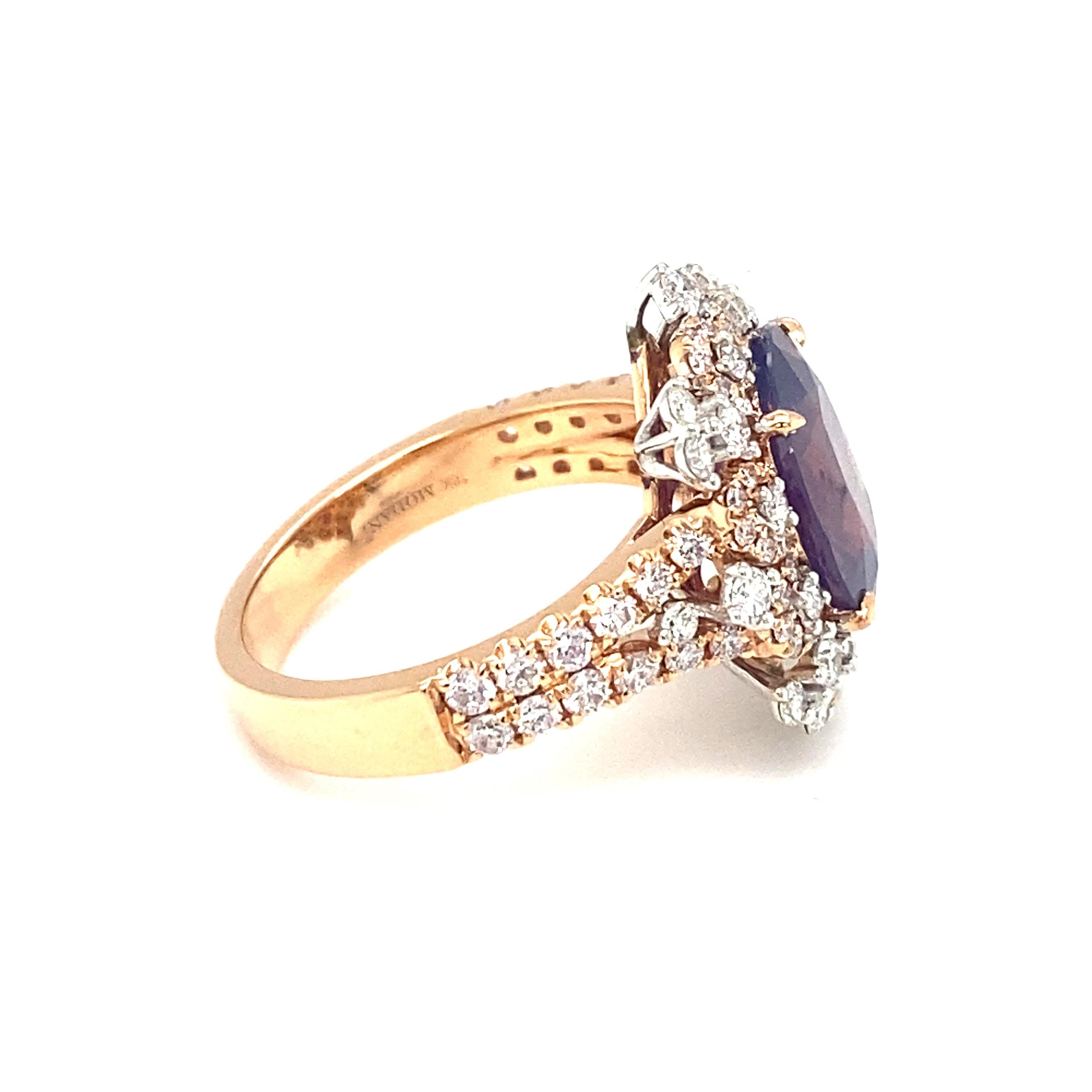Item Details: This ring by MODANI features a spectacular center purplish-pink sapphire with a halo of accent diamonds.

Circa: 2000s
Metal Type: 18 Karat Rose Gold
Weight: 7.2 grams
Size: US 7.25, resizable

Diamond Details:
Carat: 0.75 carat total