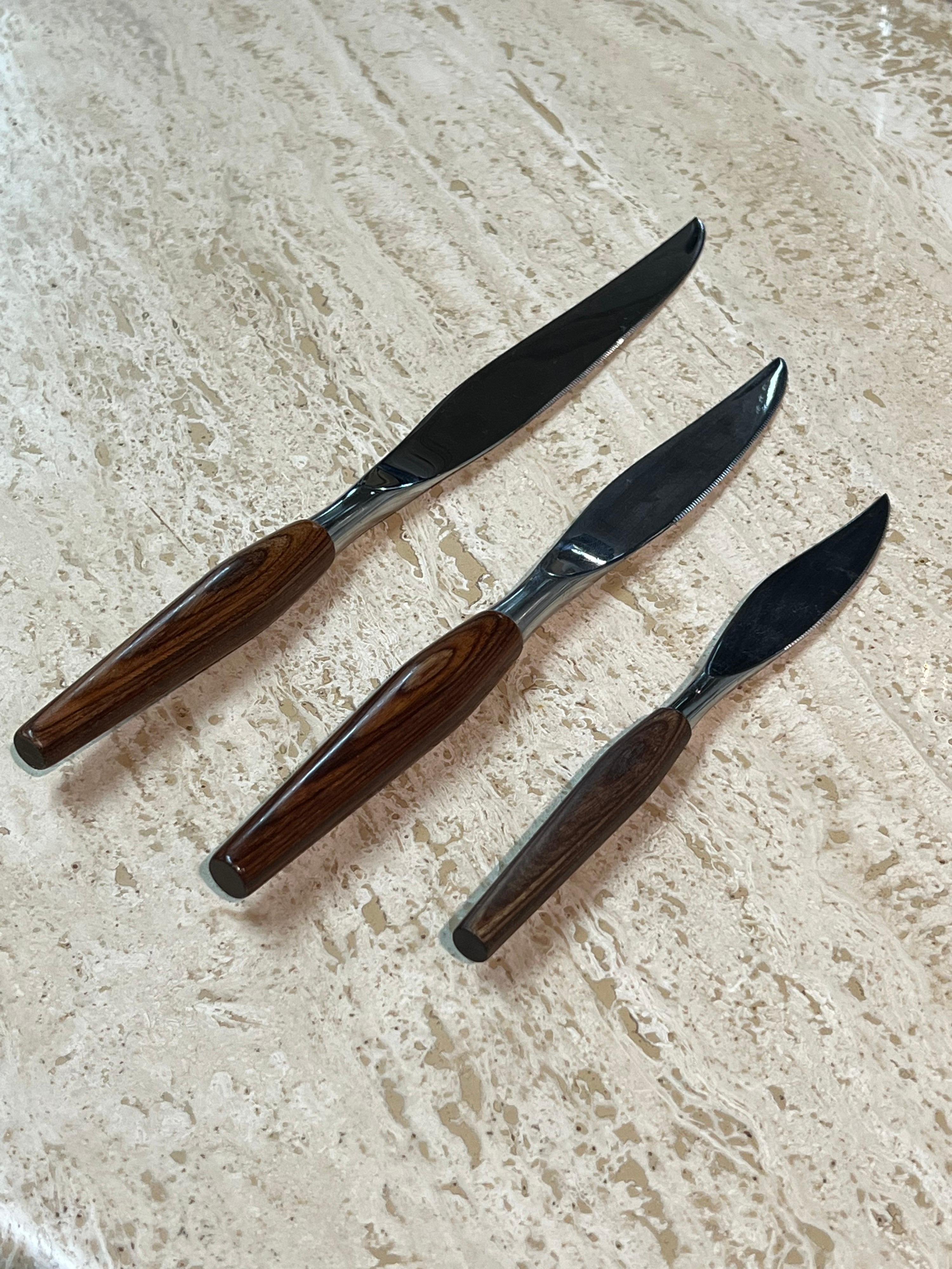 Set of three carving and all purpose stainless steel knives with rosewood handles by Sheffield of England.

Separate Dimensions:
Large: H 12.75