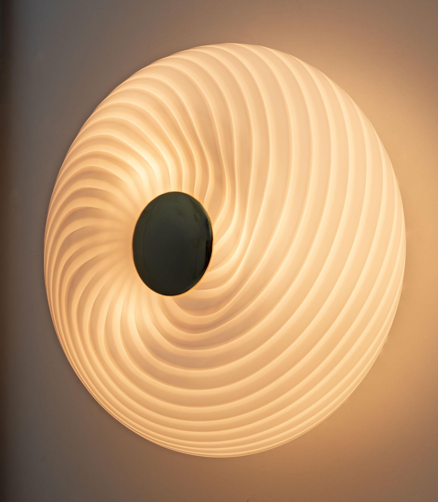 The unusual Murano glass spiral lamp, model 048 by Leucos, was made in Italy in the seventies. It can be used as a ceiling, table or wall lamp.

Founded in 1962 in Scorzè, on the outskirts of Venice, and subsequently moved to the Salzano district,