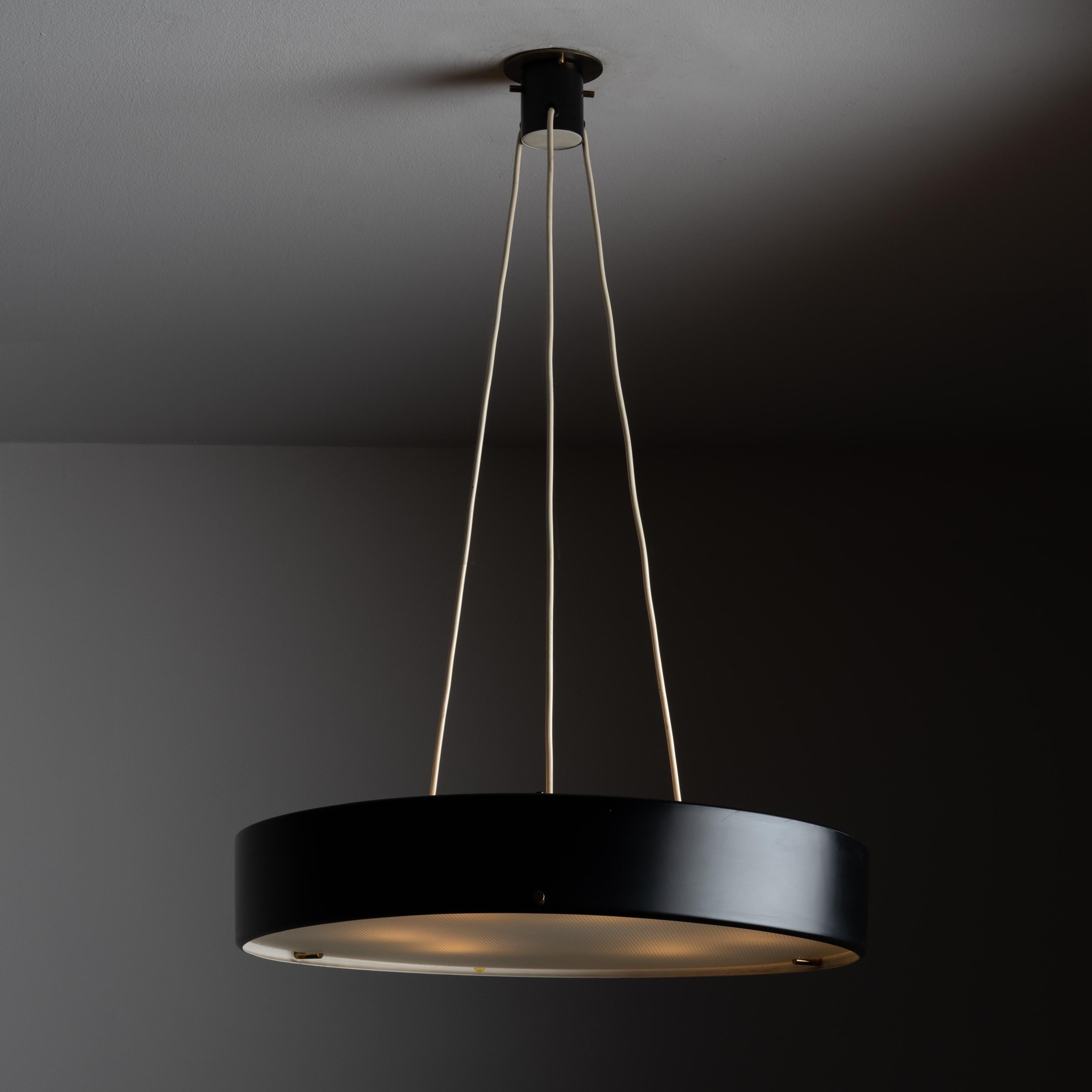 Model 1090 ceiling light by Bruno Gatta for Stilnovo. Designed and manufactured in Italy, circa 1954. Large drum made out of black enameled aluminum, brass details and textured opaline glass. This diffuser gives off a soft muddled light. Holds six