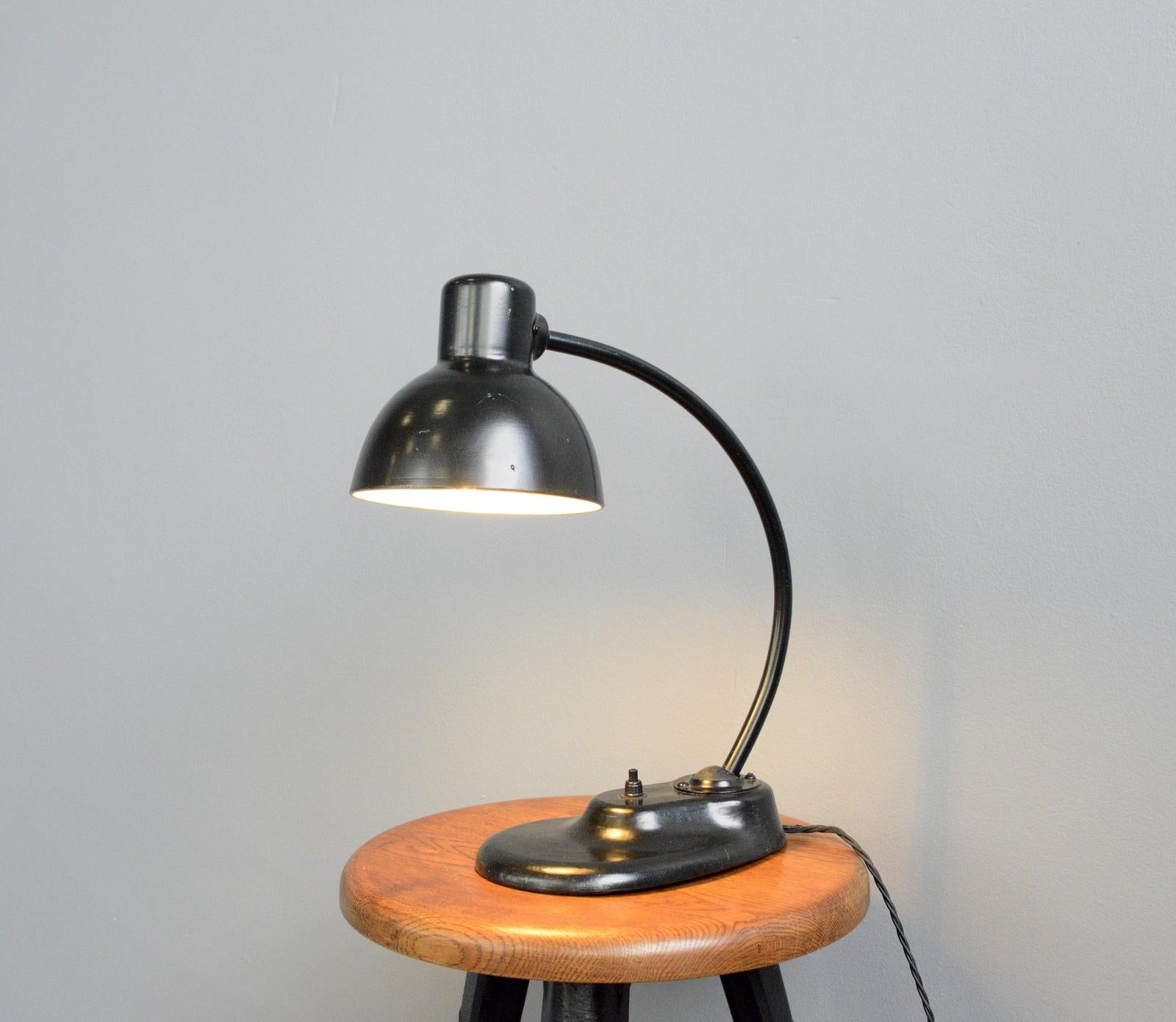 Model 1115 table lamp by Kandem, circa 1930s


Kandem

German lamp manufacturer Kandem was founded in Leipzig in 1889. From its establishment in 1919 Kandem was always closely connected with the Bauhaus school, purchasing and manufacturing many
