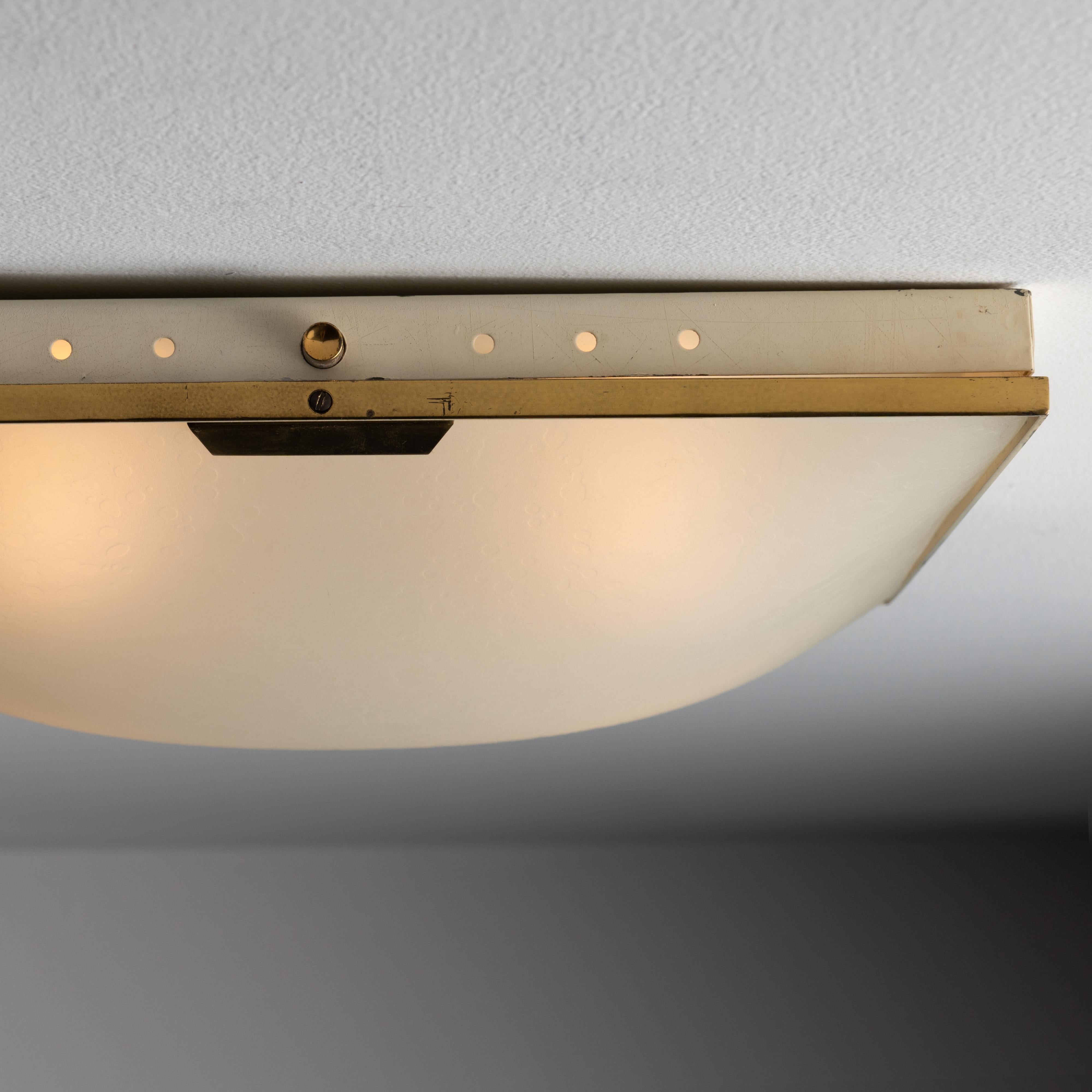 Model 1136 Flush Mount by Stilnovo. Designed and manufactured in Italy circa the 1960s. Textured translucent glass sets the seen on these subtle, gorgeous flush mounts. Very iconic Stilnovo design from this era. Holds four E14 socket types, adapted