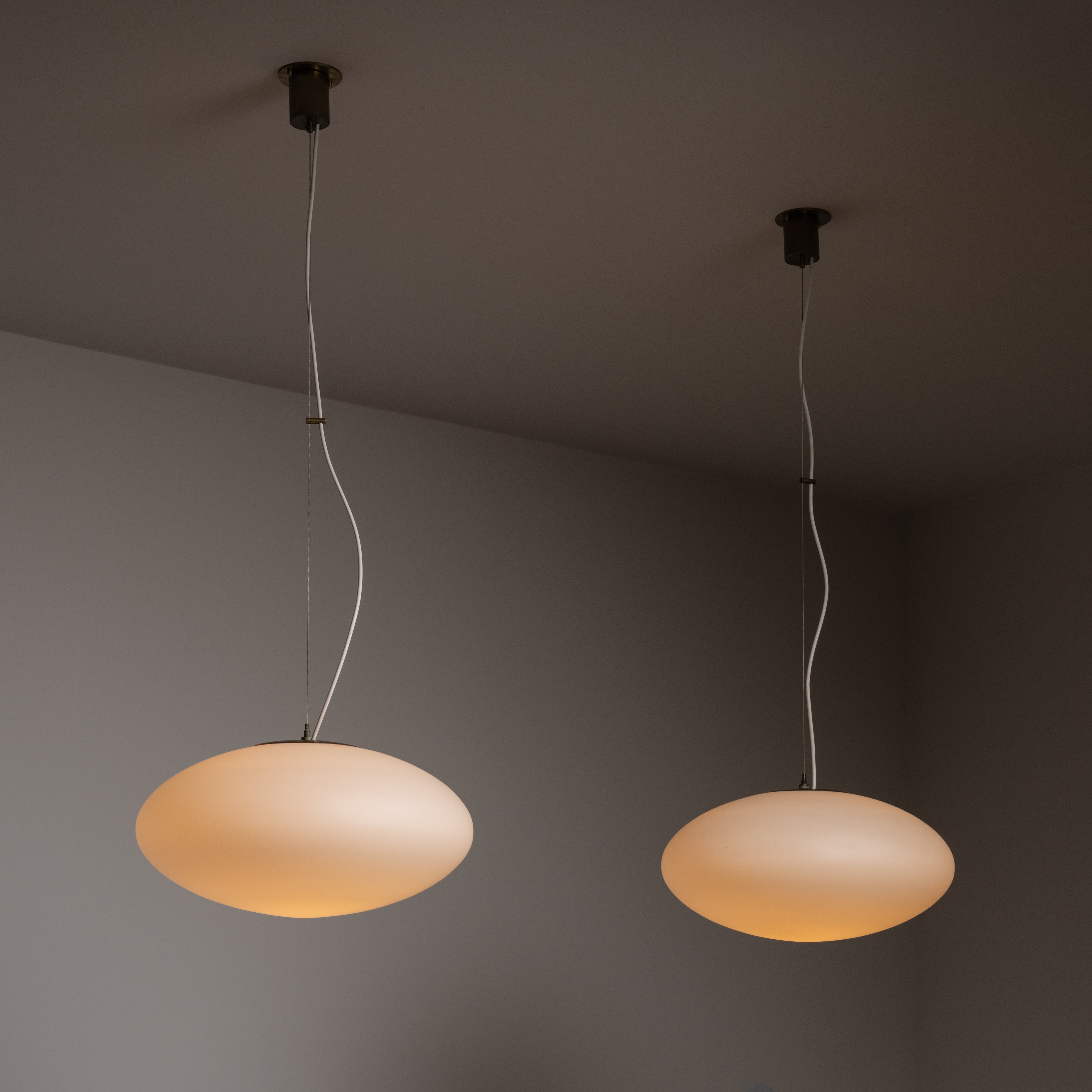Single Model 1187 Ceiling Lamp by Gaetano Sciolari for Stilnovo. Designed and manufactured in Italy, circa the 1970s. Opaline glass orbs suspended by steel cable. Brass hardware and accents on the canopy. Length is slightly adjustable with wire