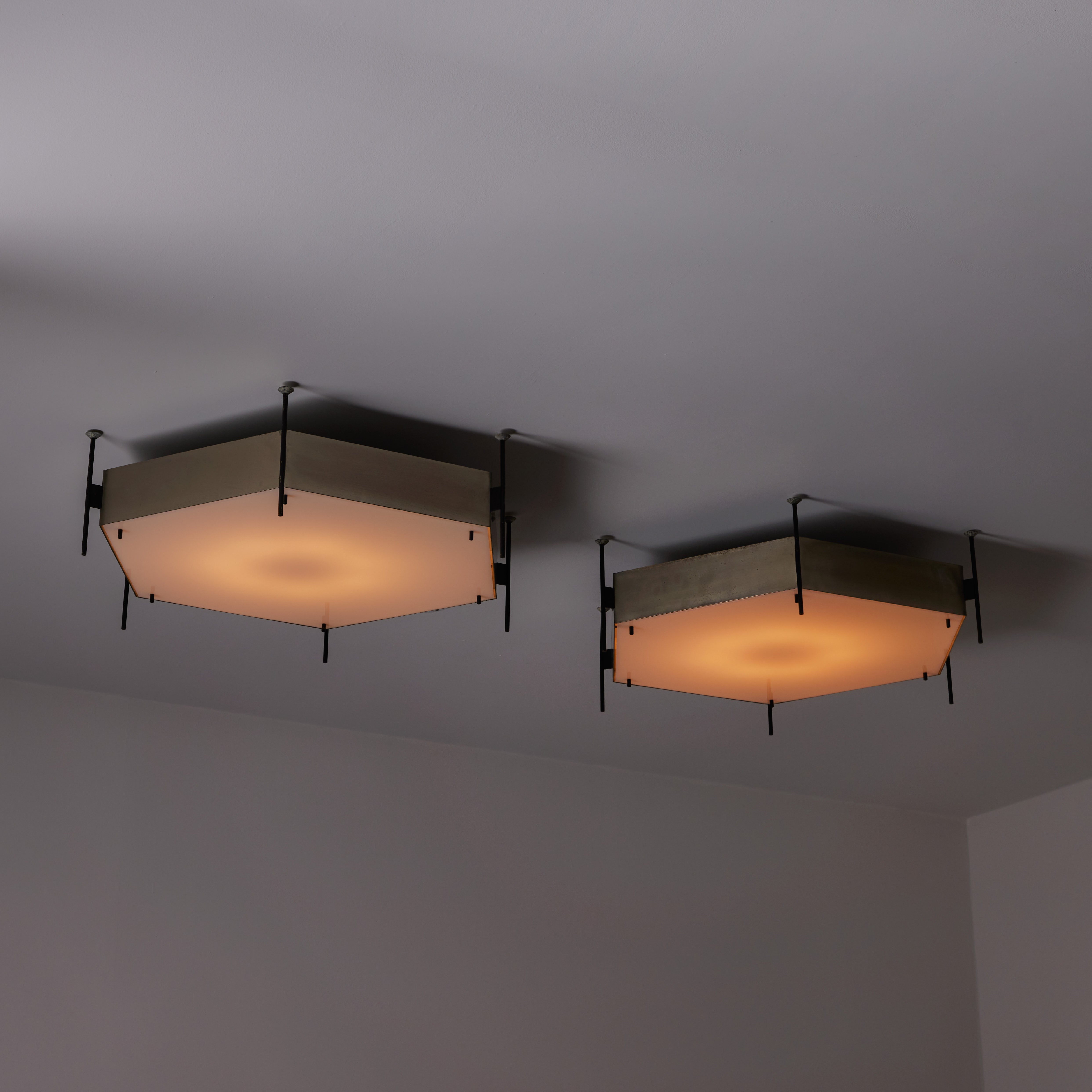 Model 12712 Ceiling Lights by Angelo Lelli for Arredoluce. Designed and manufactured in Italy, in 1958. Hexagonal mounted lights which are made of a sturdy steel hexagon frame, enameled steel accents on the exterior, and acrylic diffusers. The frame