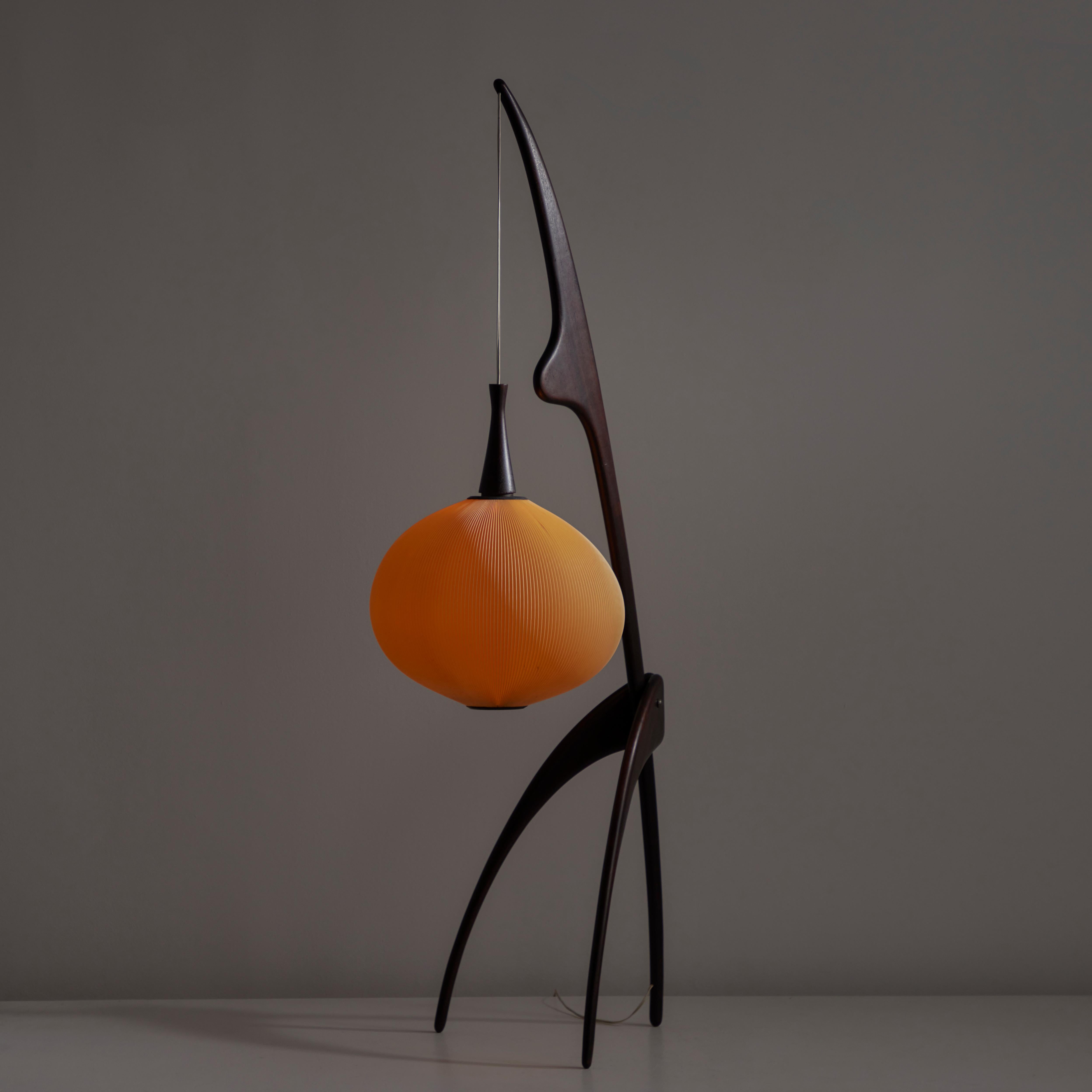 Model 14.950 'Praying Mantis' Floor Lamp by Rispal. Designed and manufactured in France, circa 1950. Iconic and original floor lamp with a dark strained wooden frame, and insect like tri-pod legs, and suspended spherical shade fabricated from ribbed