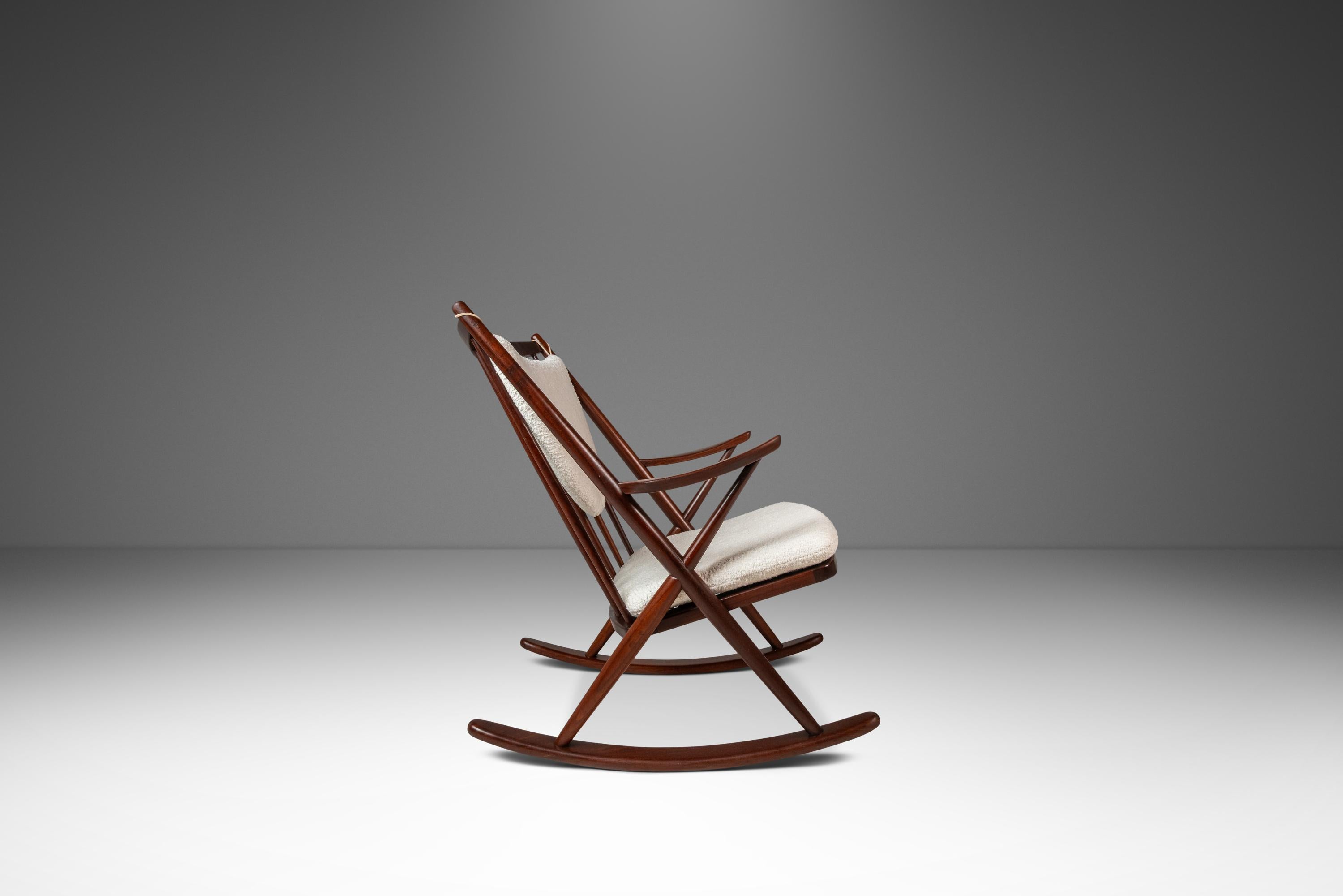 Introducing an iconic Model No. 182 Rocking Chair by Frank Reenskaug for Bramin Mobler. Constructed from a frame of solid Burmese teak in excellent original condition this instantly recognizable rocker features new white cotton bouclé upholstery by