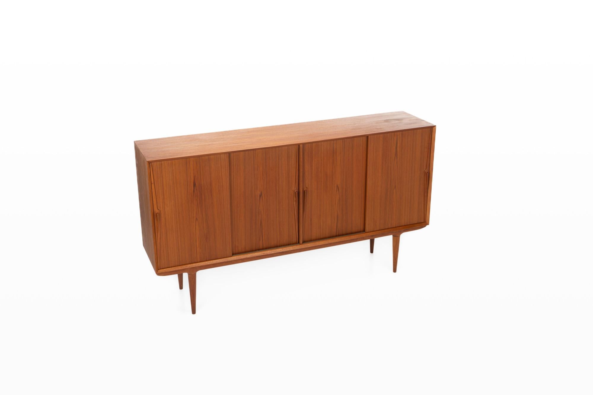This beautiful teak highboard was designed for Omann Jun Møbelfabrik in Denmark. The sideboard has four sliding doors and a lot of storage space. Designed as Model 19 and marked by the producer.