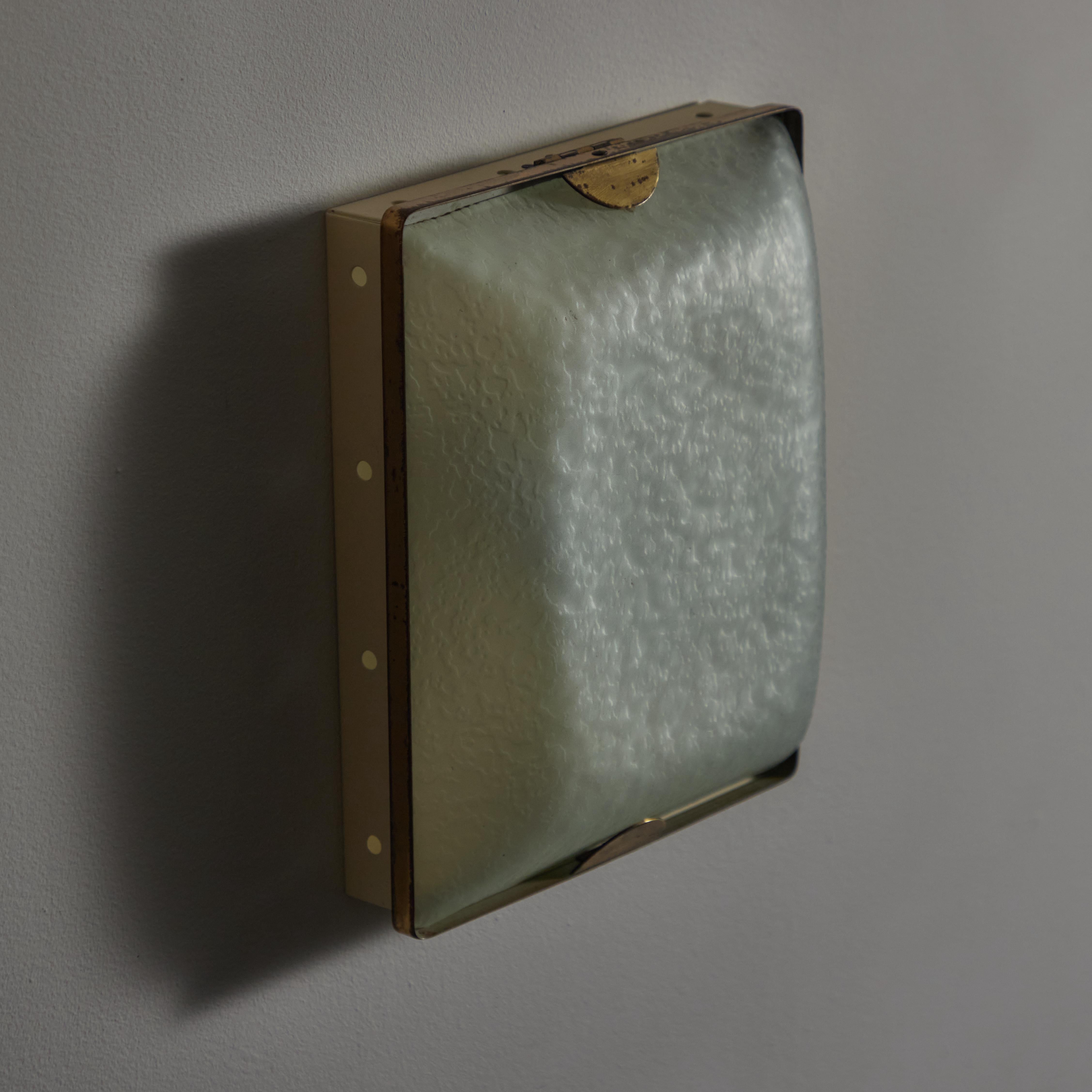 Single Model 1938 Wall or Ceiling Light by Fontana Arte. Designed and manufactured in Italy, circa the 1950s. Classic flush mount consisting of textured blue/green glass and a simple enameled backplate system. The rectangle version holds three of