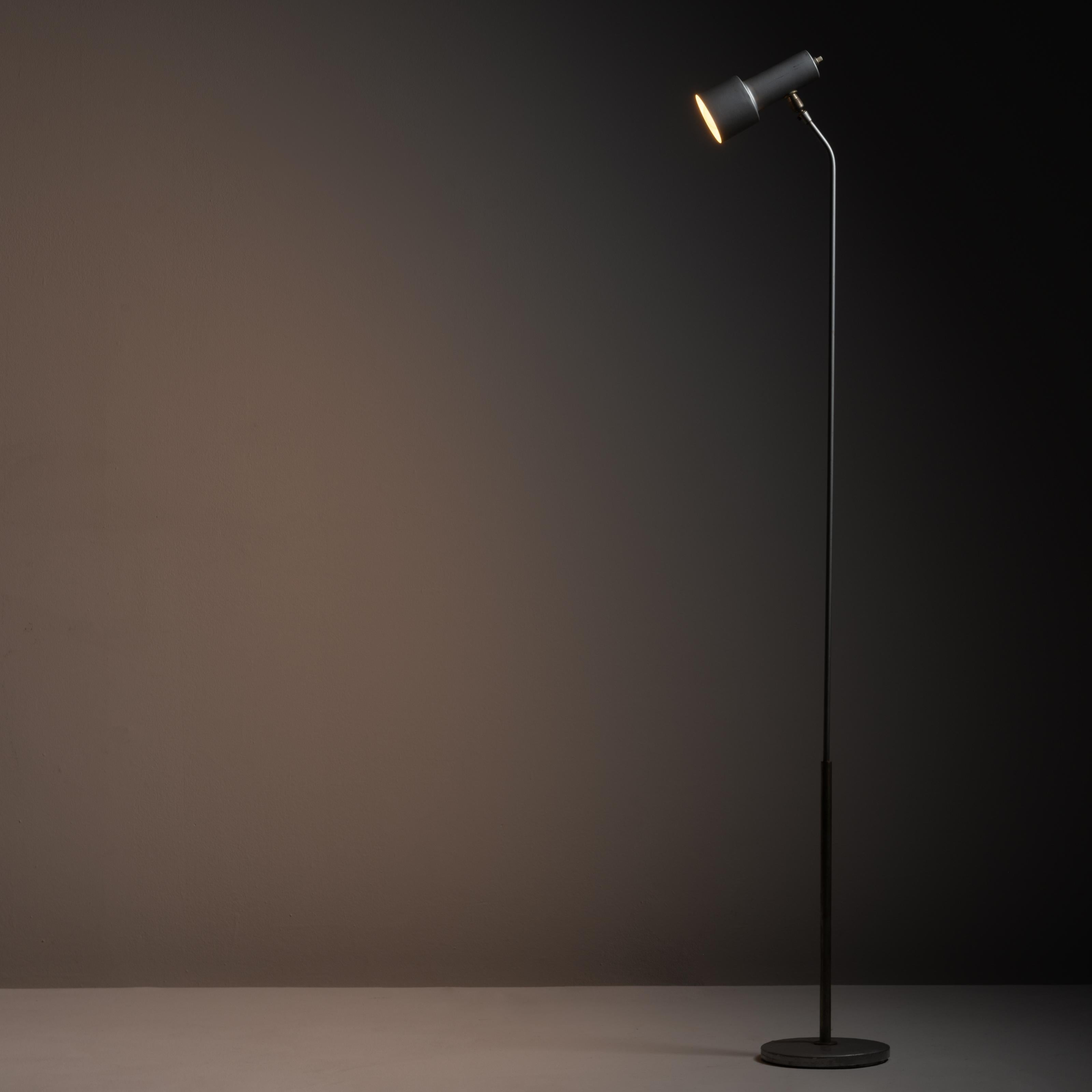 Model 1968 floor lamp by Fontana Arte. Designed and manufactured in Italy, circa the 1060s. Slender metal frame floor lamp sits on a cast iron shrink lacquered base. The shade can be adjusted with the ball joint hardware attached to shade. Push