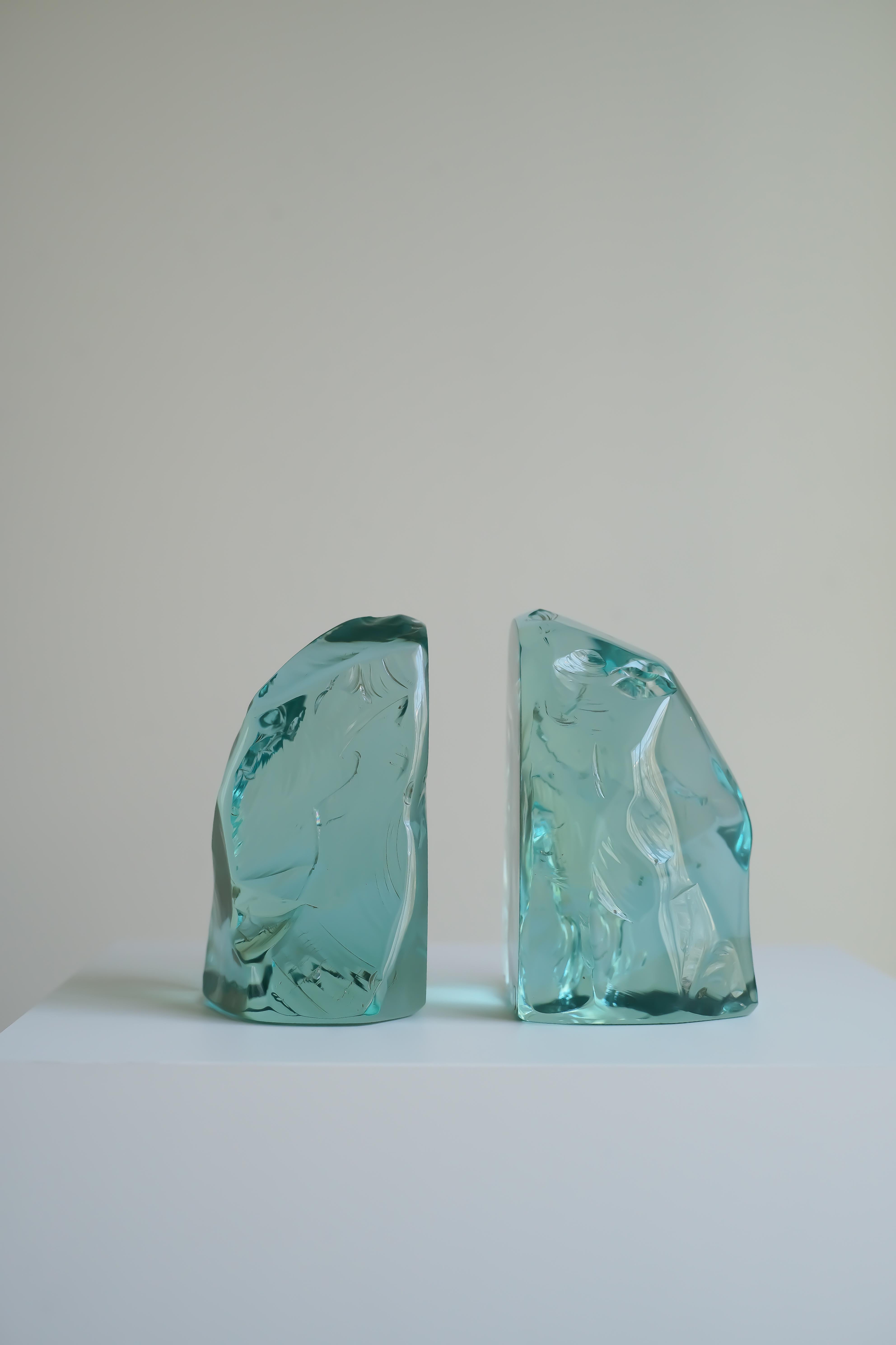 A pair of luminous turquoise crystal 1977 bookends by Max Ingrand for Fontana Arte, c.1960s. The maker’s mark is visible at the base of one of the bookends.

FontanaArte was founded in Milan (as Fontana Arte) iby Luigi Fontana and Giò Ponti in 1932.