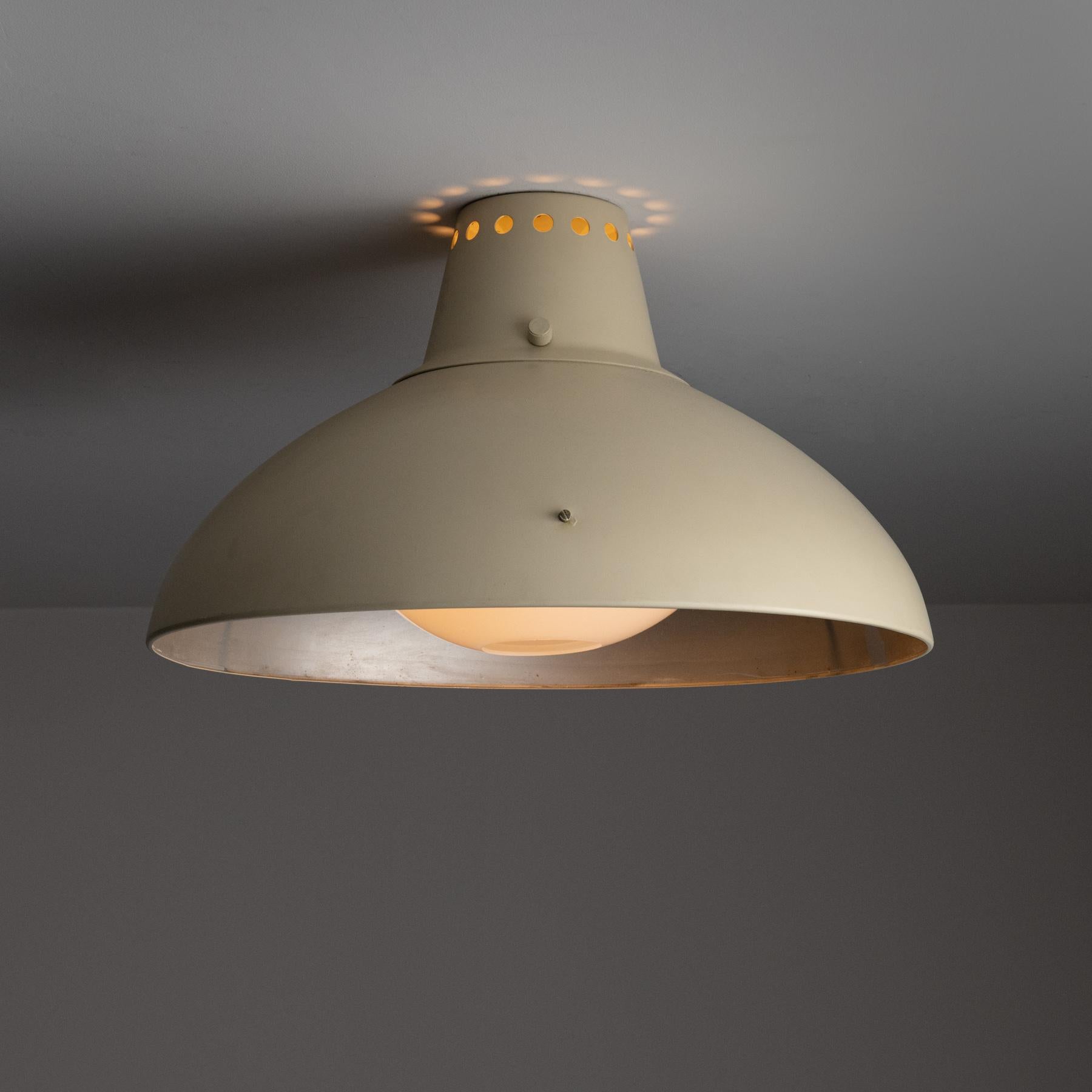 Model 2096 Flush Mount by Gino Sarfatti for Arteluce. Designed and manufactured in Italy, in 1958. An enameled formed shade supported by a tri-arm brace. An acrylic diffuser sits within this shade with a small punch hole, allowing for subtle back