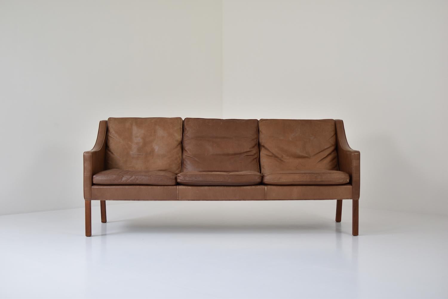 Stunning patinated leather three-seat by Børge Mogensen for Fredericia, Denmark 1960s. This is Model 2209 and features the original cognac brown leather upholstery which is beautifully been patinated over the years. Nice curved armrests and back.
