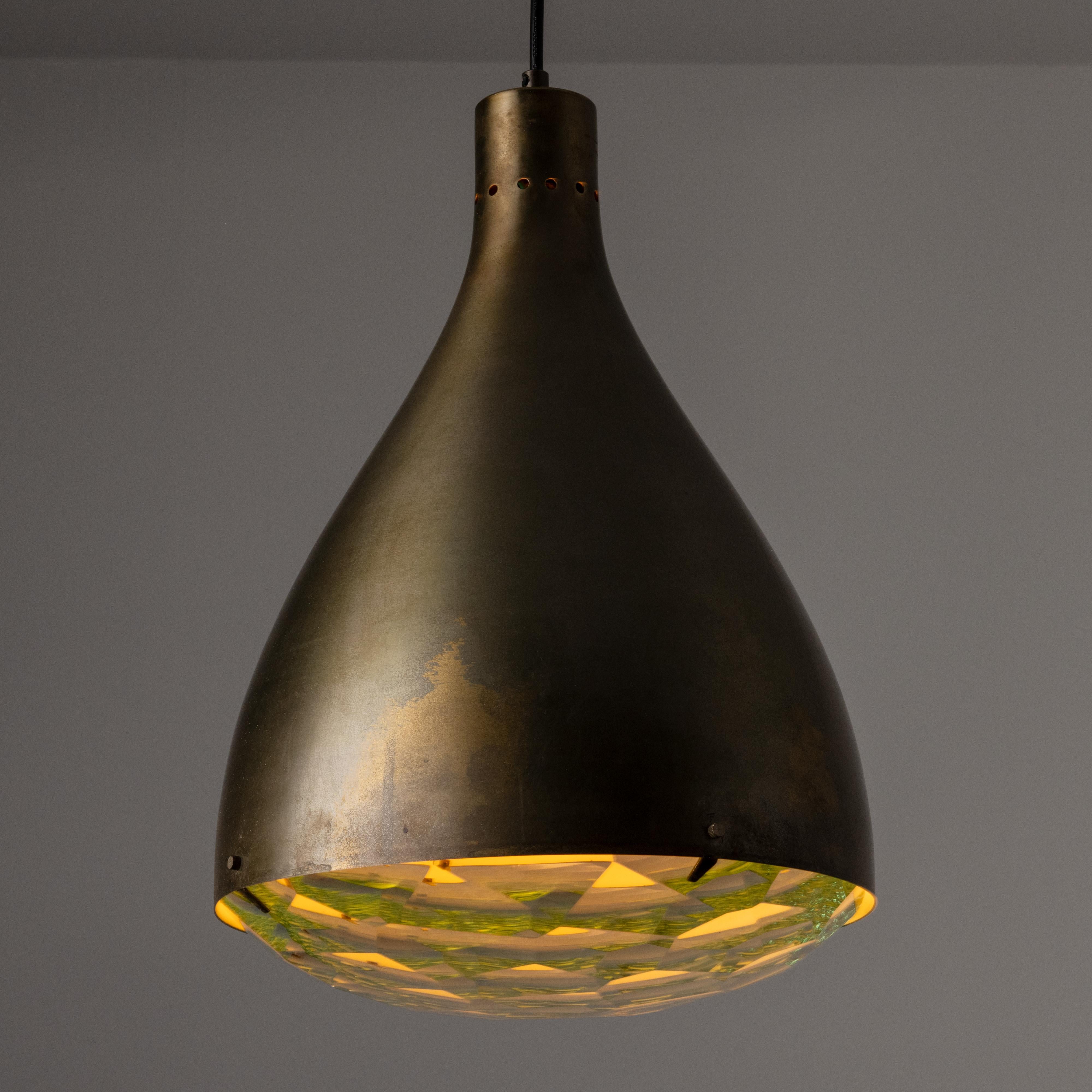 Model 2220 Ceiling Light by Max Ingrand for Fontana Arte. Designed and manufactured in Italy, circa the 1960s. A teardrop formed brass shade makes up the exterior portion of this simple but striking pendant. The bottom diffuser holds a geometric