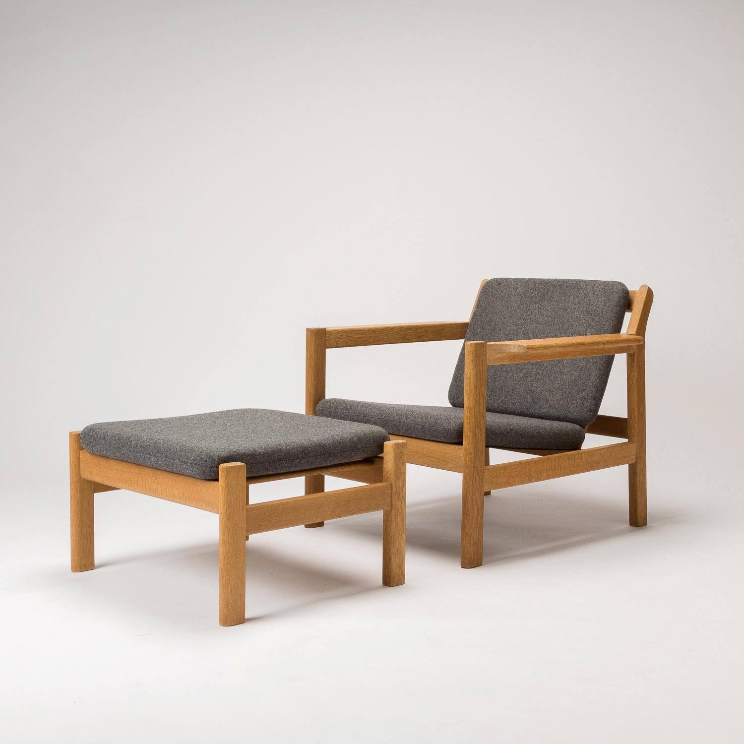 An oak model 227 armchair with model 228 footstool designed by Børge Mogensen for Fredericia. Newly upholstered in charcoal grey Kvadrat Divina Melange 3 pure new wool with new cushions. Excellent condition.