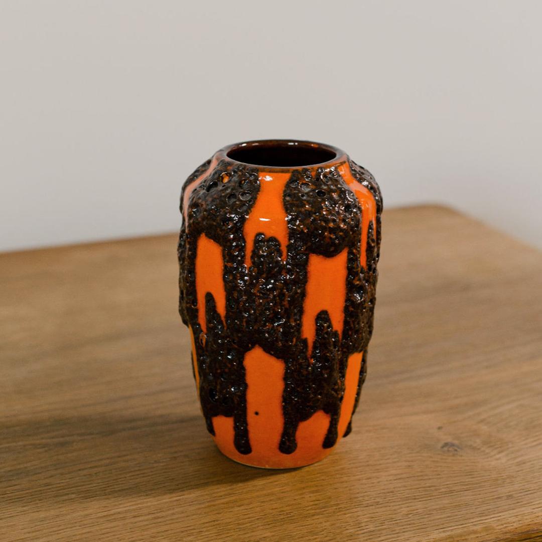 A model 238-18 orange glazed ceramic vase by Scheurich with lava textured design with interior glazing. Marked on base. 