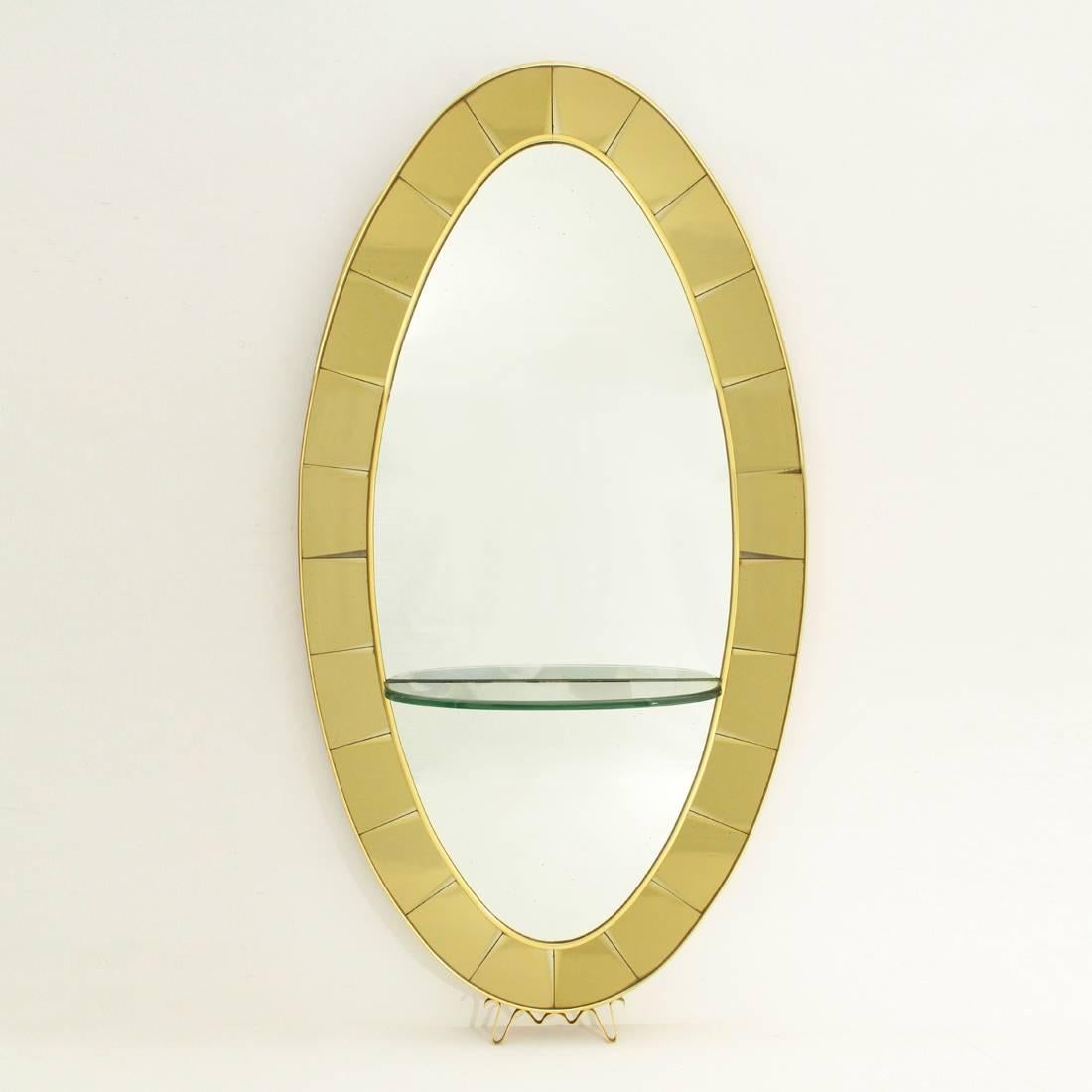 Mirror with shelf produced in the 1950s by Cristal Art.
Oval wooden frame.
Oval mirror in mirrored glass,
framed by colored mirrored glass tesserae with bevelled edges.
Shelf in thick glass with bevelled edges at different angles.
Side frame