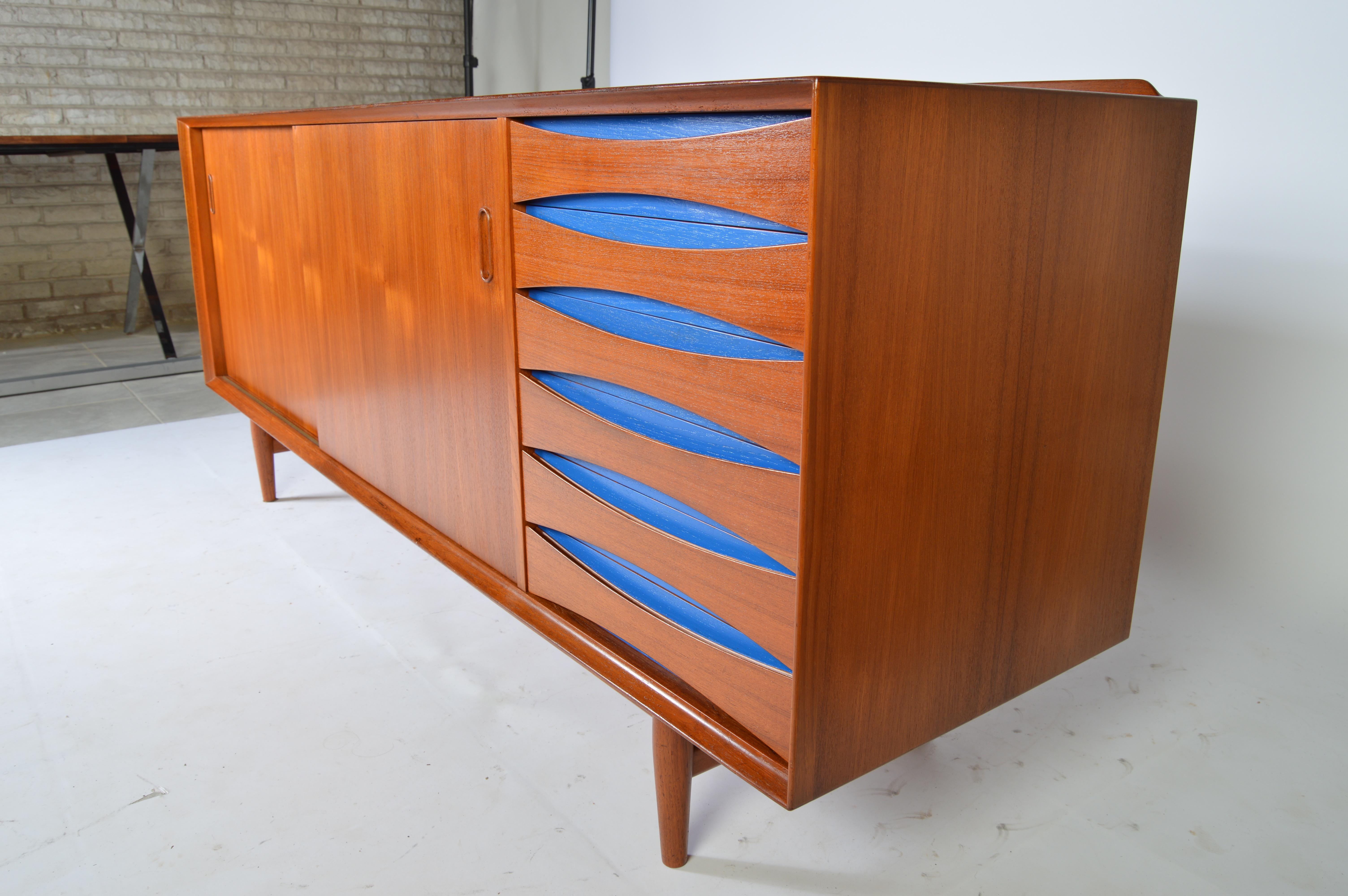 A stunning model 29 credenza by Arne Vodder for Sibast having blue detail inside the drawer pulls. Signed with original manufacturer's label and tagged with production detail sheet inside the case, underneath of the drawers.