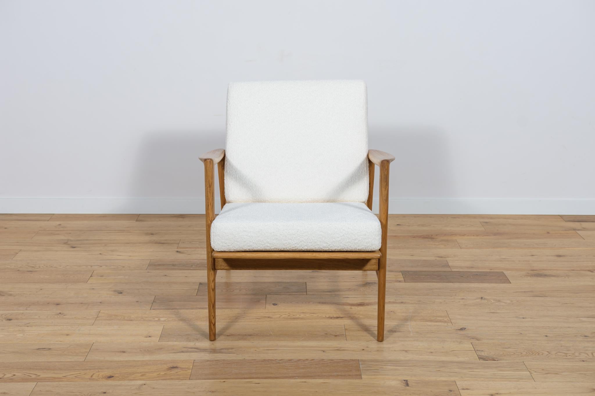 The armchair model 300-139 that was produced by the Polish company Swarzędzka Furniture Factory. Comfortable armchair with a unique form.  Armchair have been professionally restored. The wooden structure has been cleaned and polished with a oak wax.