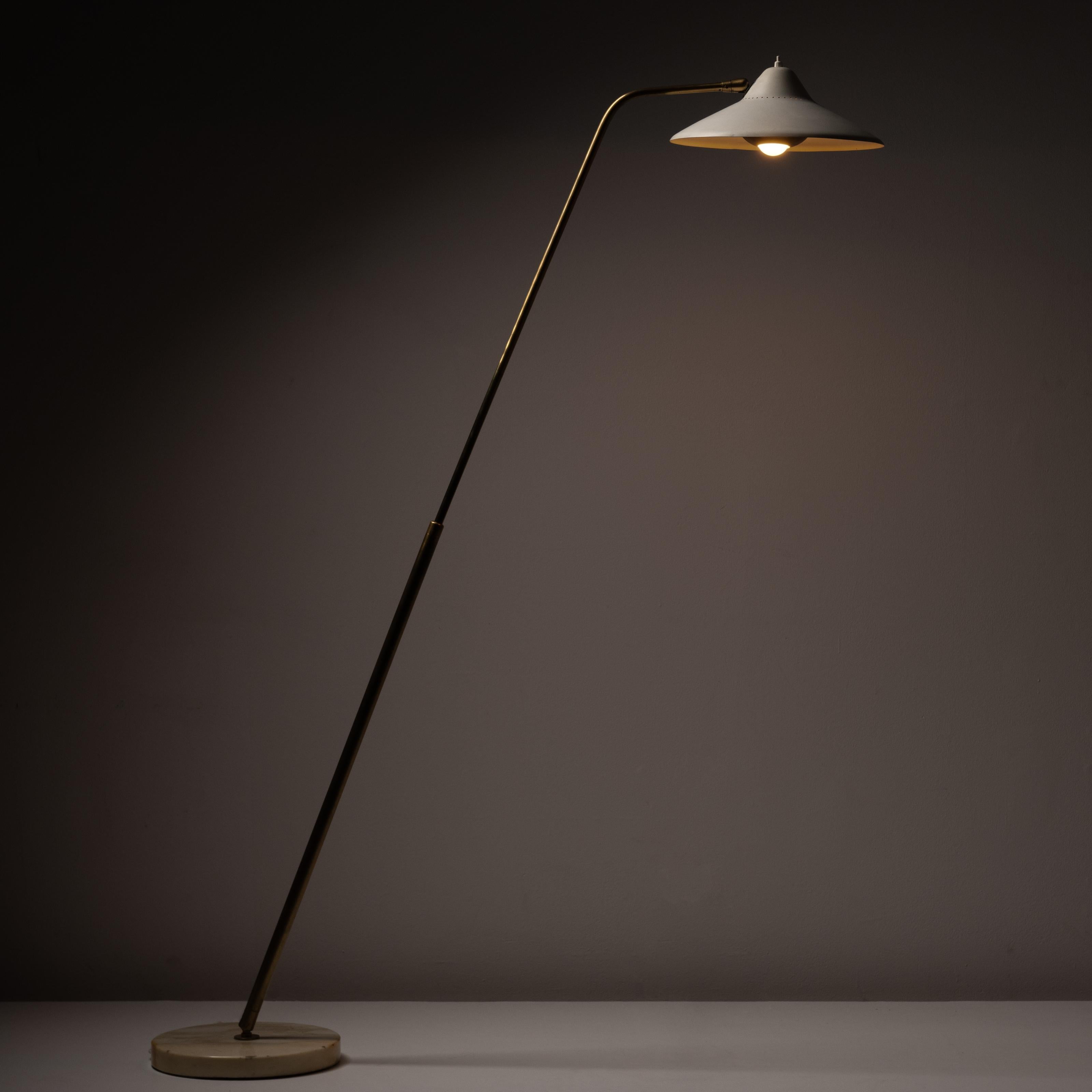 'Model 301C Floor Lamp' by Giuseppe Ostuni for Oluce. Designed and manufactured in Italy, in 1950. Beautiful and rare floor lamp with a sanded marble base with an extractable and anatomic brass stem. The shade is constructed of enameled aluminum