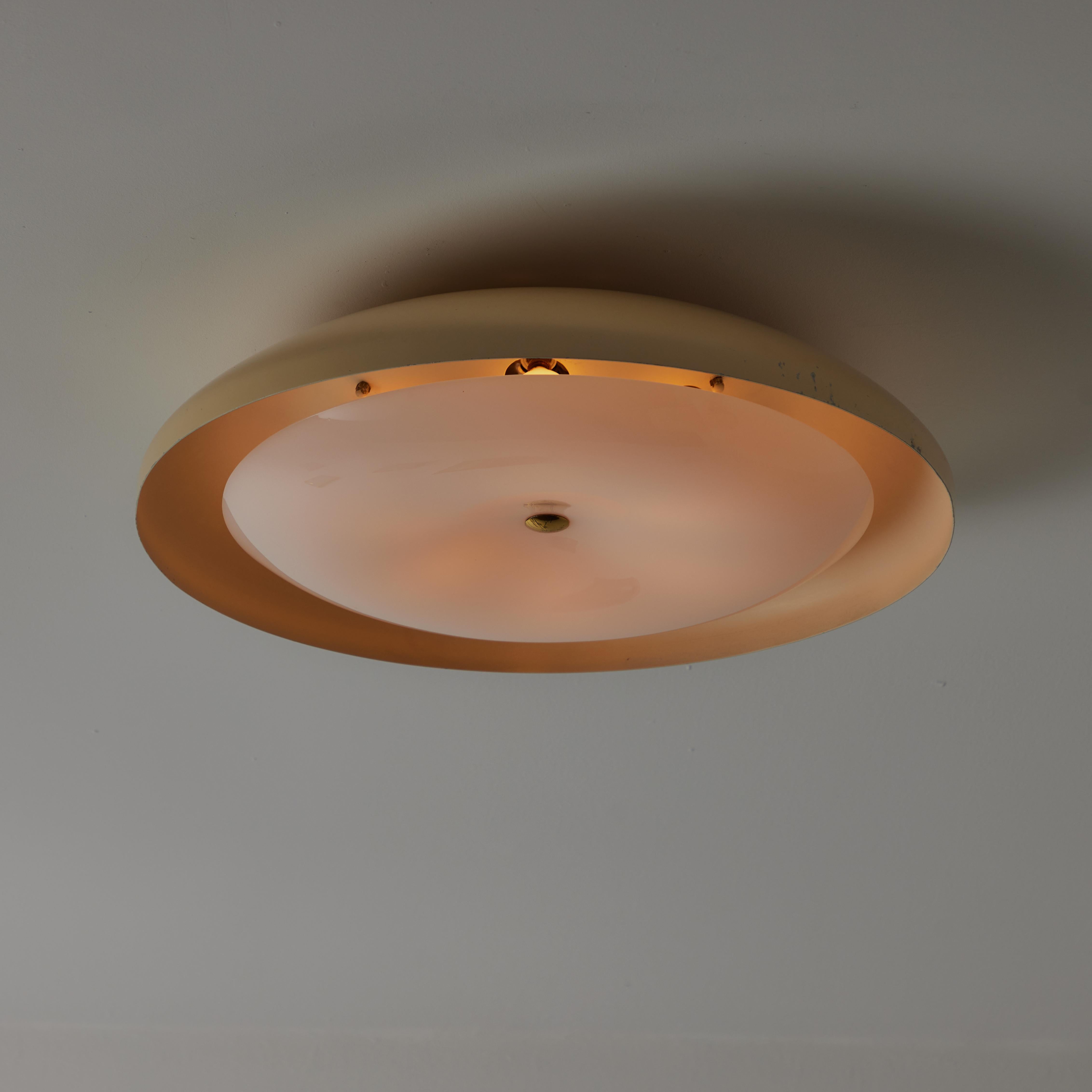 Model 3020 Flush Mount by Gino Sarfatti for Arteluce. Italy circa the 1960s. Molded lucite diffuser with a center dimple; adding dimensional intrigue. The light holds seven e14 socket types adapted for the US. We recommend 15-25 w bulbs or LED