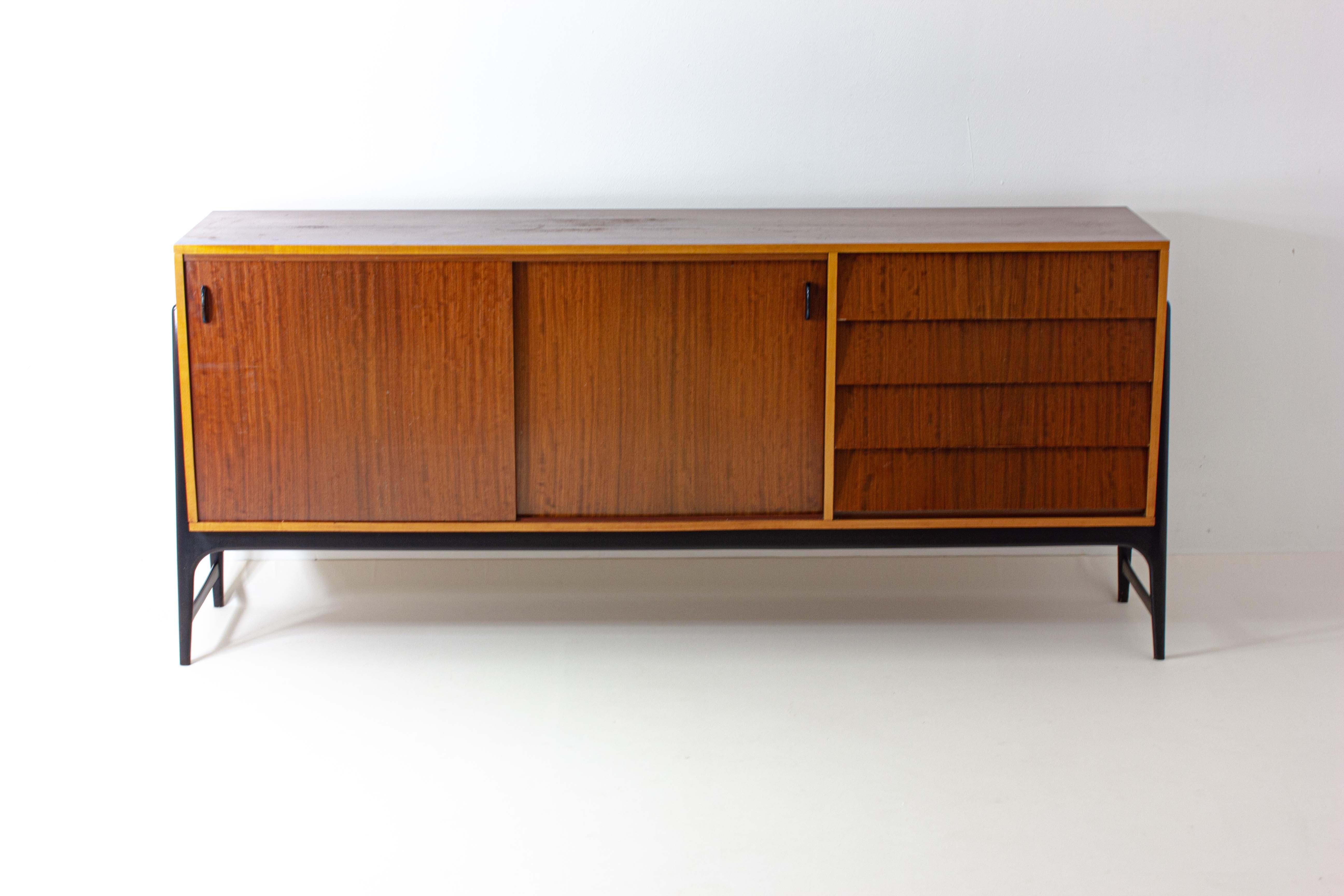 This rare sideboard is the epitome of true mid-century European design with its sleek lines in combination with organic forms. The natural materials make for an interesting play between the honey colored sycamore wood and the darker bubinga. Its