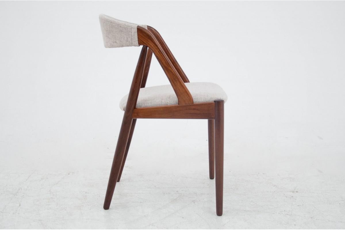 A set of four teak chairs designed by Kai Kristiansen. Classic cult model 31. Light, stable, interesting construction. The chairs have undergone wood renovation, the upholstery on the seats and backrests has been replaced with a new