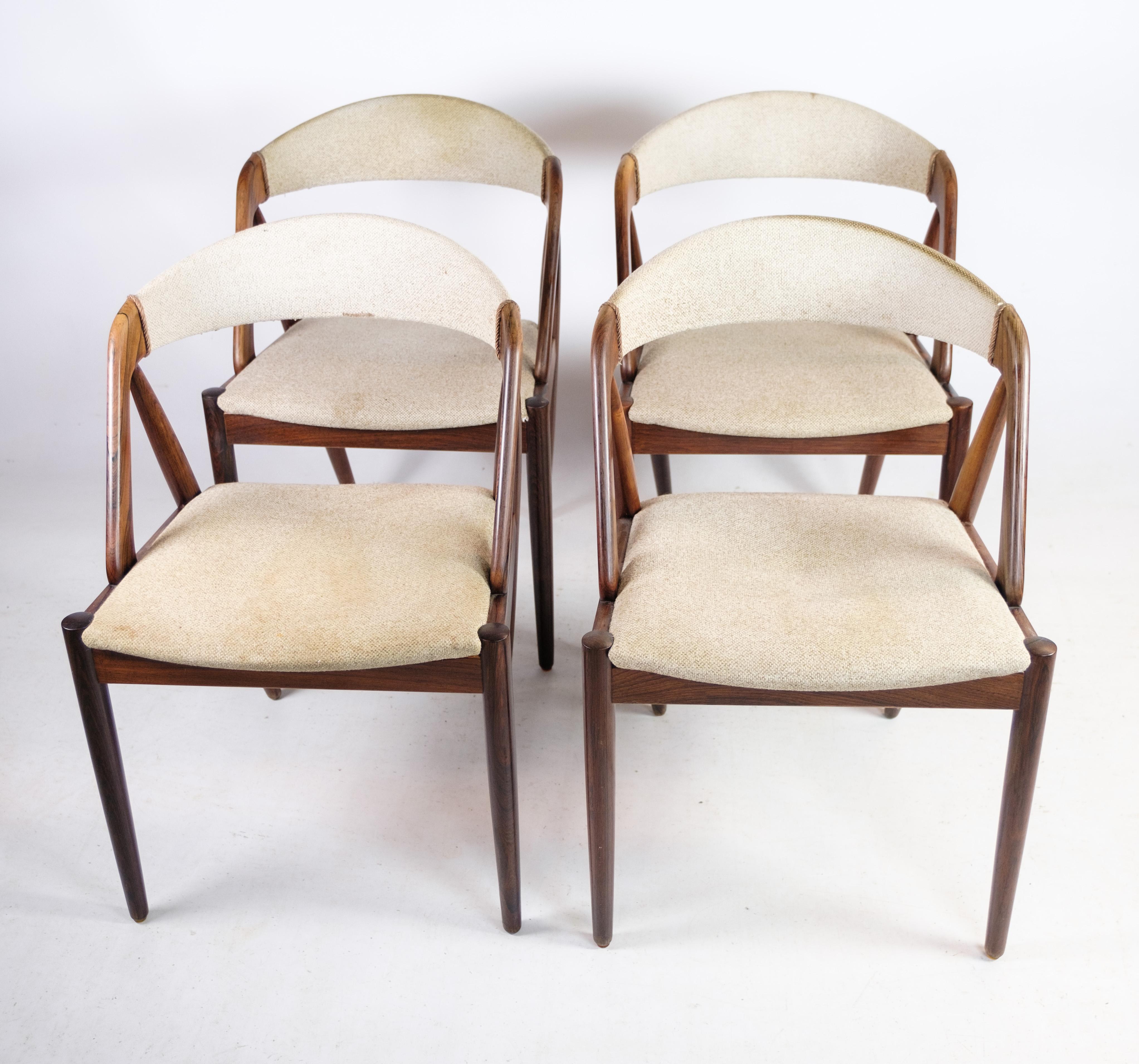 A set of four dining room chairs, model 31, designed by the renowned Danish designer Kai Kristiansen around the 1960s. These exquisite chairs are crafted with rosewood frames by Schou Andersen, showcasing the timeless elegance of mid-century Danish