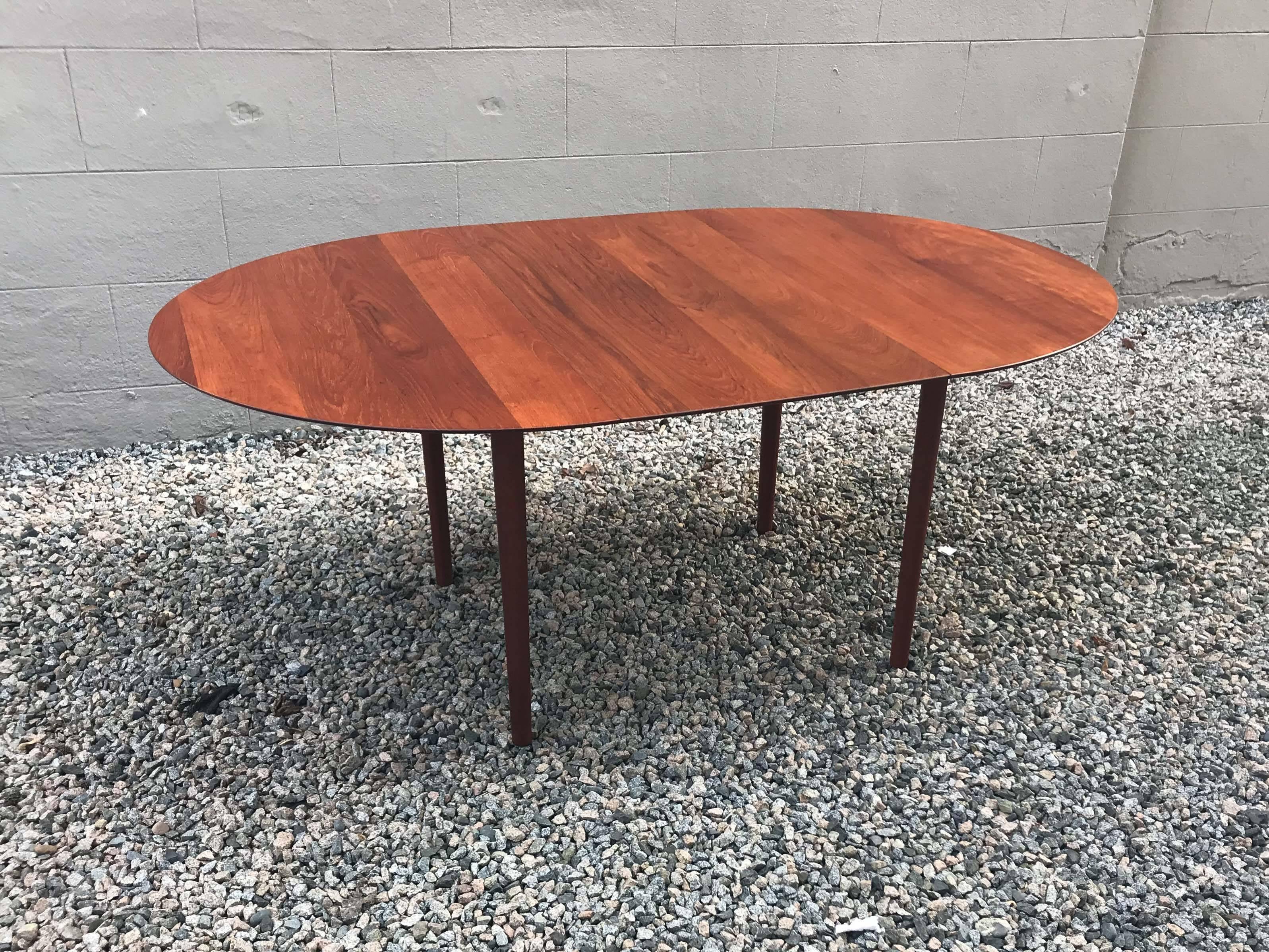 Solid teak model 311 table by Peter Hvidt & Orla Mølgaard-Nielsen for Søborg Møbler, designed in 1956. Marked with original stamp and label.

This table is unique in that the shape of the top is slightly elliptical and extendable with the original