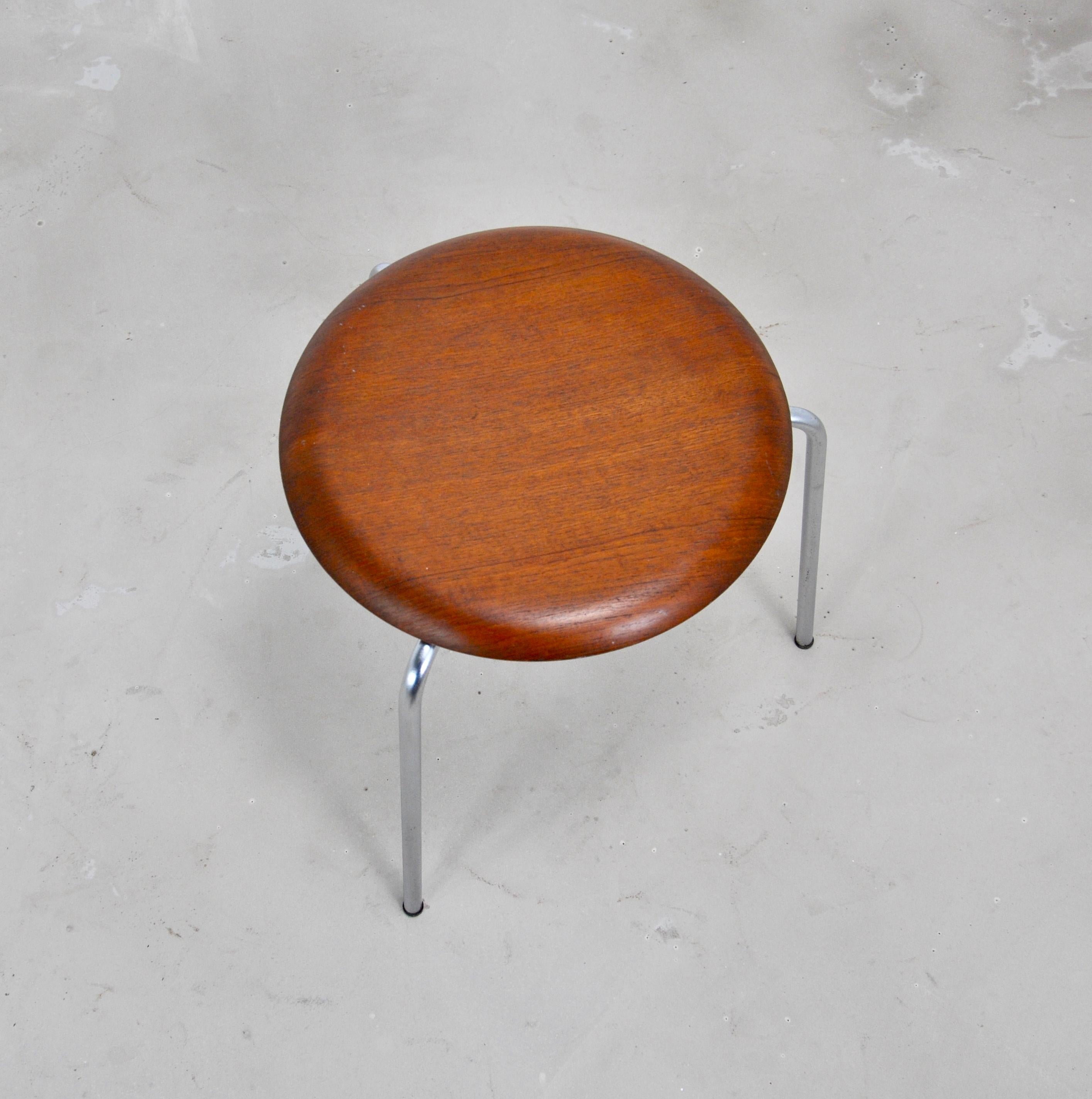 Stool by Arne Jacobsen, chromed metal base. Seat in teak. Stamped under the seat (see photo).