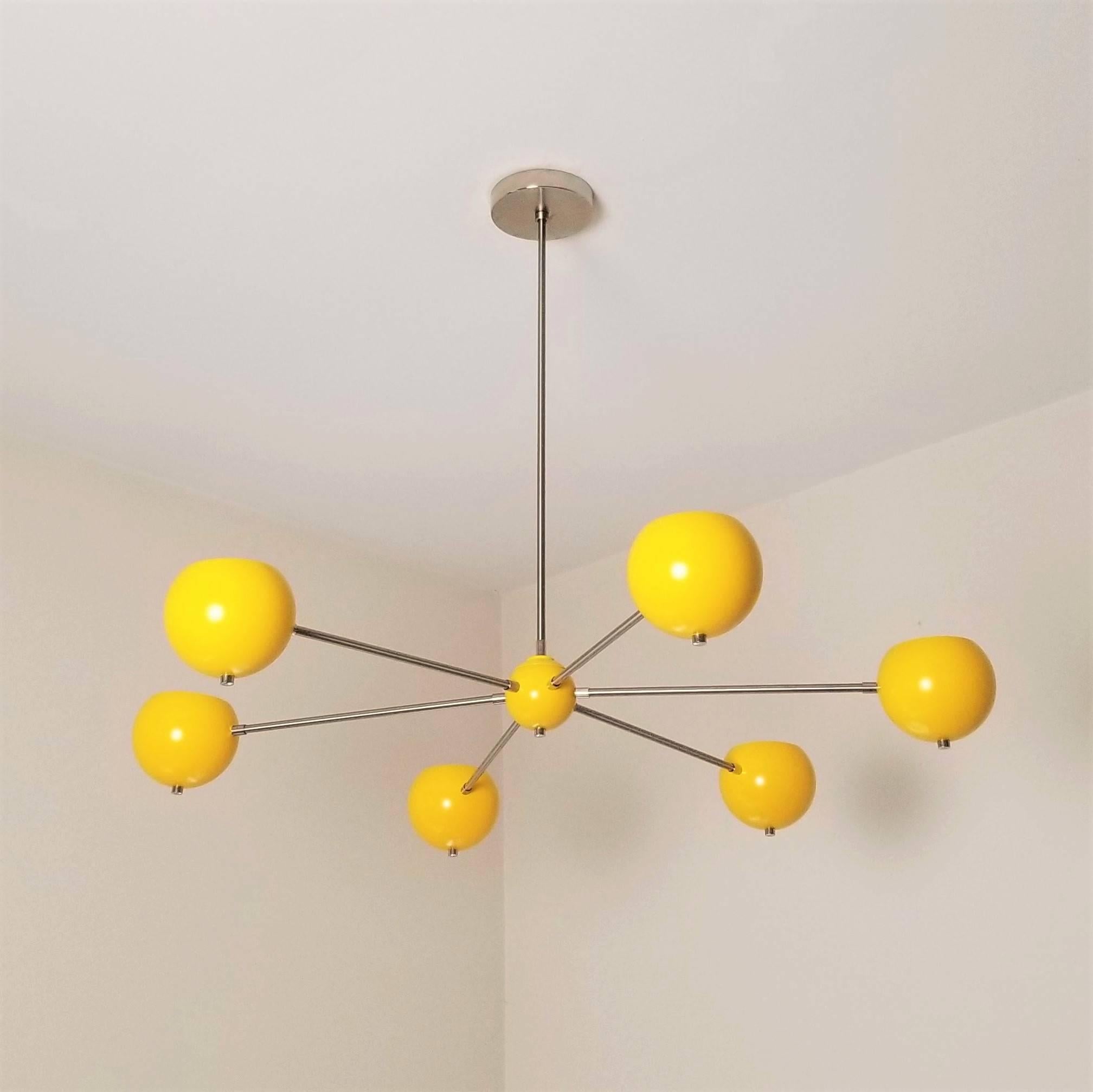 Our standard enamel colors are shown in the final images--there is no additional lead time or cost for these colors.

Introducing the model 320, a chic, simple brass chandelier with spun aluminium orbs shown in our 'Sunrise' enamel by Blueprint