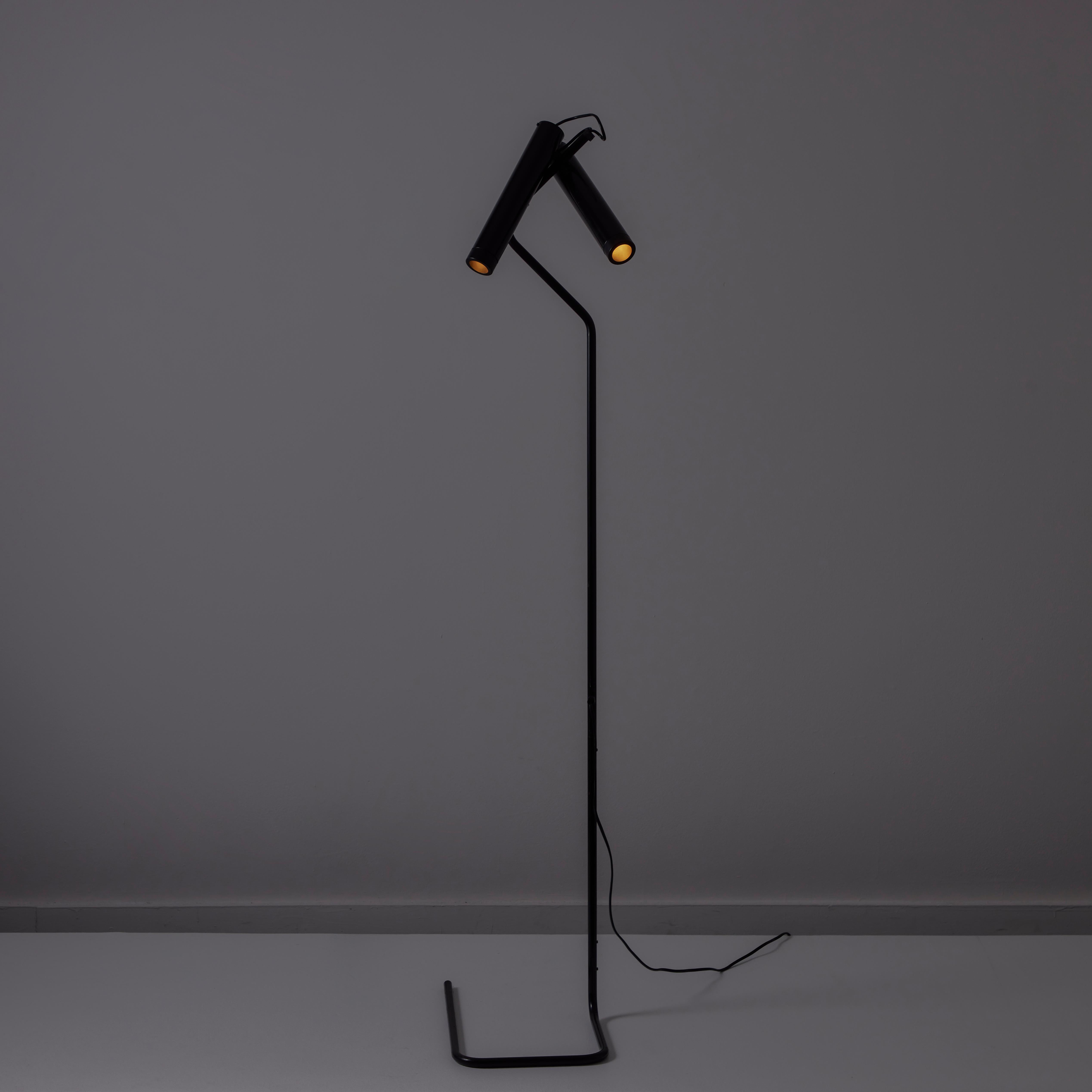 Model 321 'Idomedue' Floor Lamp by Vico Magistretti for Oluce. Designed and manufactured in Italy, circa the 1980s. A dual spotlight floor lamp comprising a minimalistic tubular base, stem system, and two cylindrical spotlights. The spotlights can