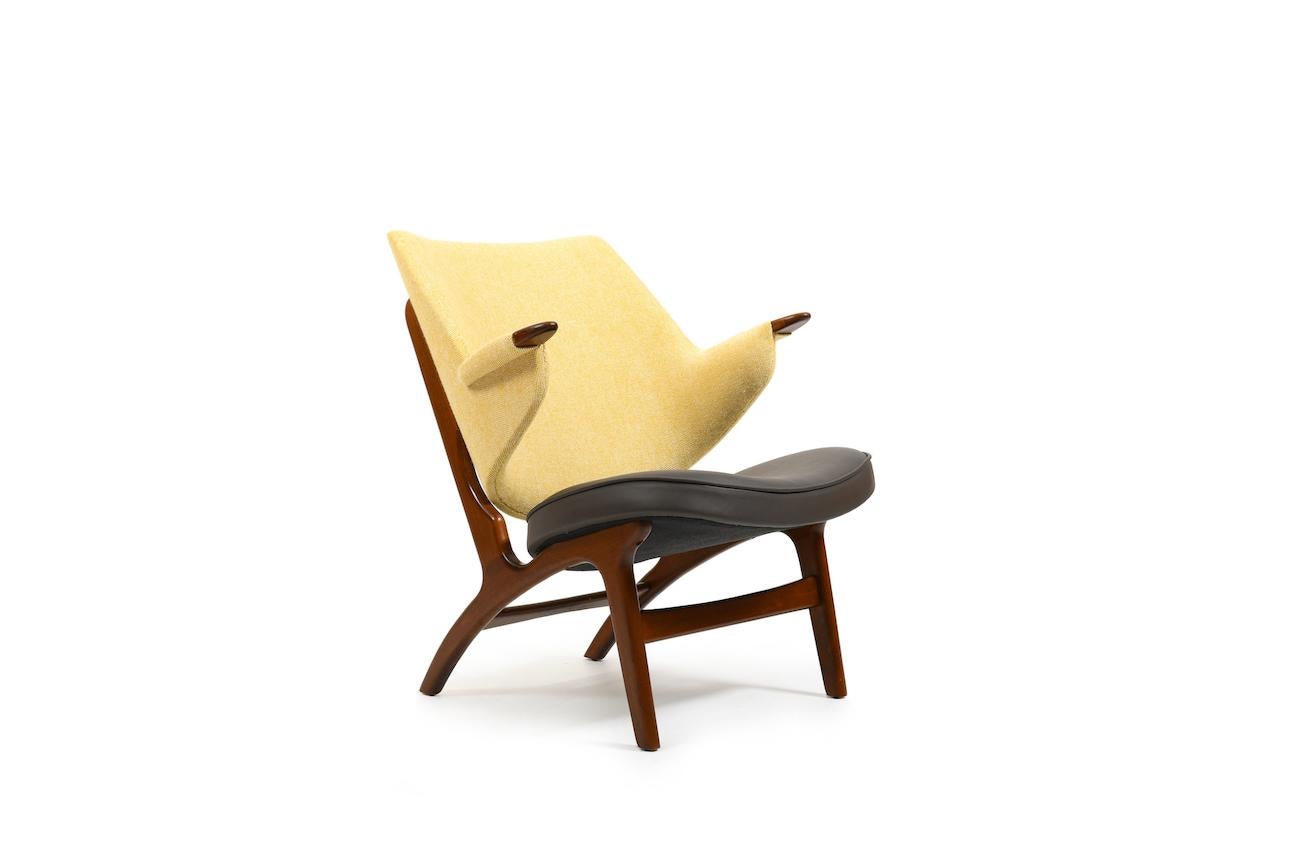 Easychair, model 33 by Carl Edward Matthes, 1952. Produced by CE Matthes Denmark. This chair was produced for only 15 years. The frame is made in beech wood. New upholstered by professional in dark brown leather with yellow/creme fabric. Early
