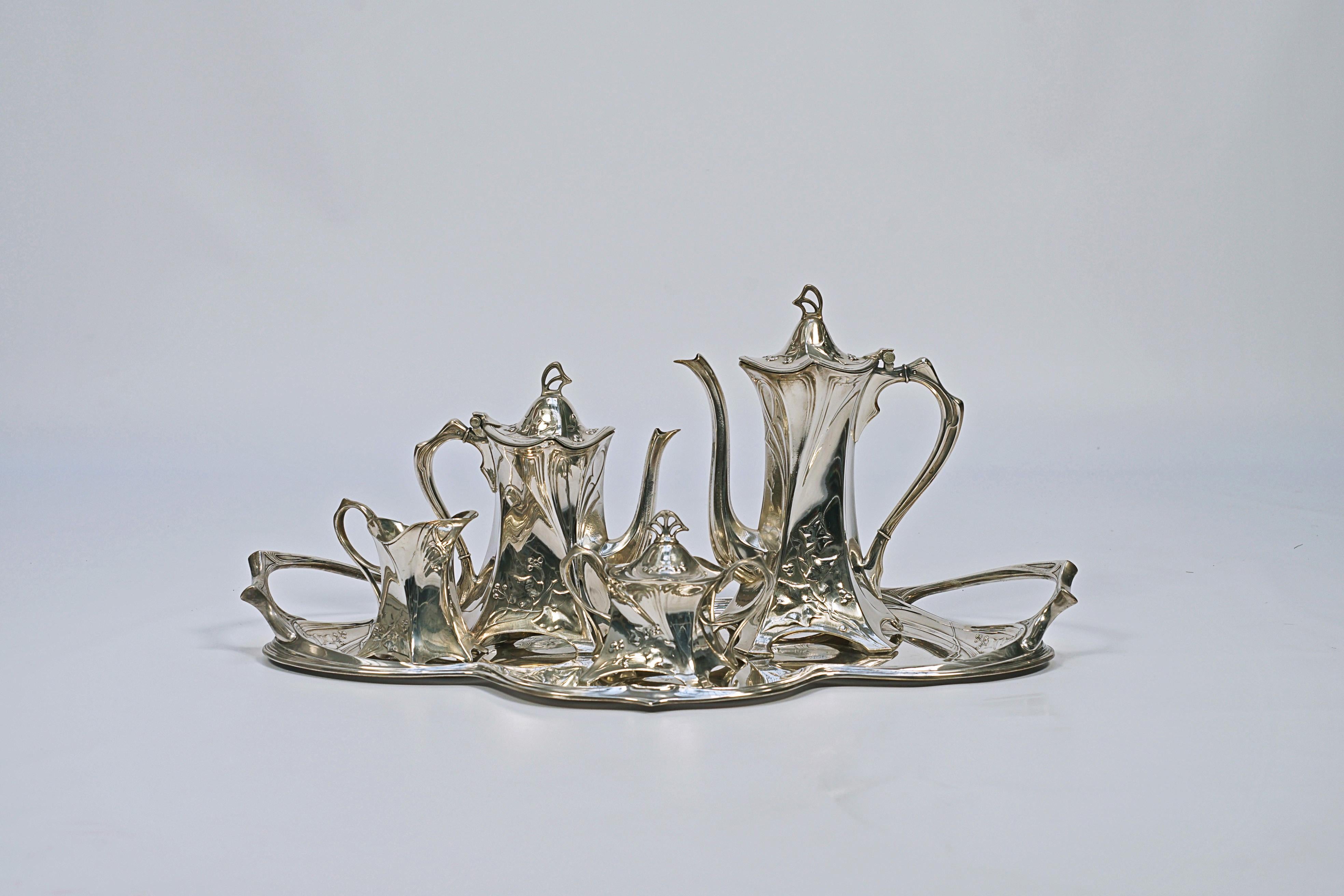 5-piece tea set made of silver-plated bronze. Made by the WMF-Württembergische Metallwarenfabrik factory (1853 to the present).

Graham Dry (1906), “Art Nouveau Domestic Metalwork, from Wurttembergische Mettalwsarenfabrick”, Antique Collectors