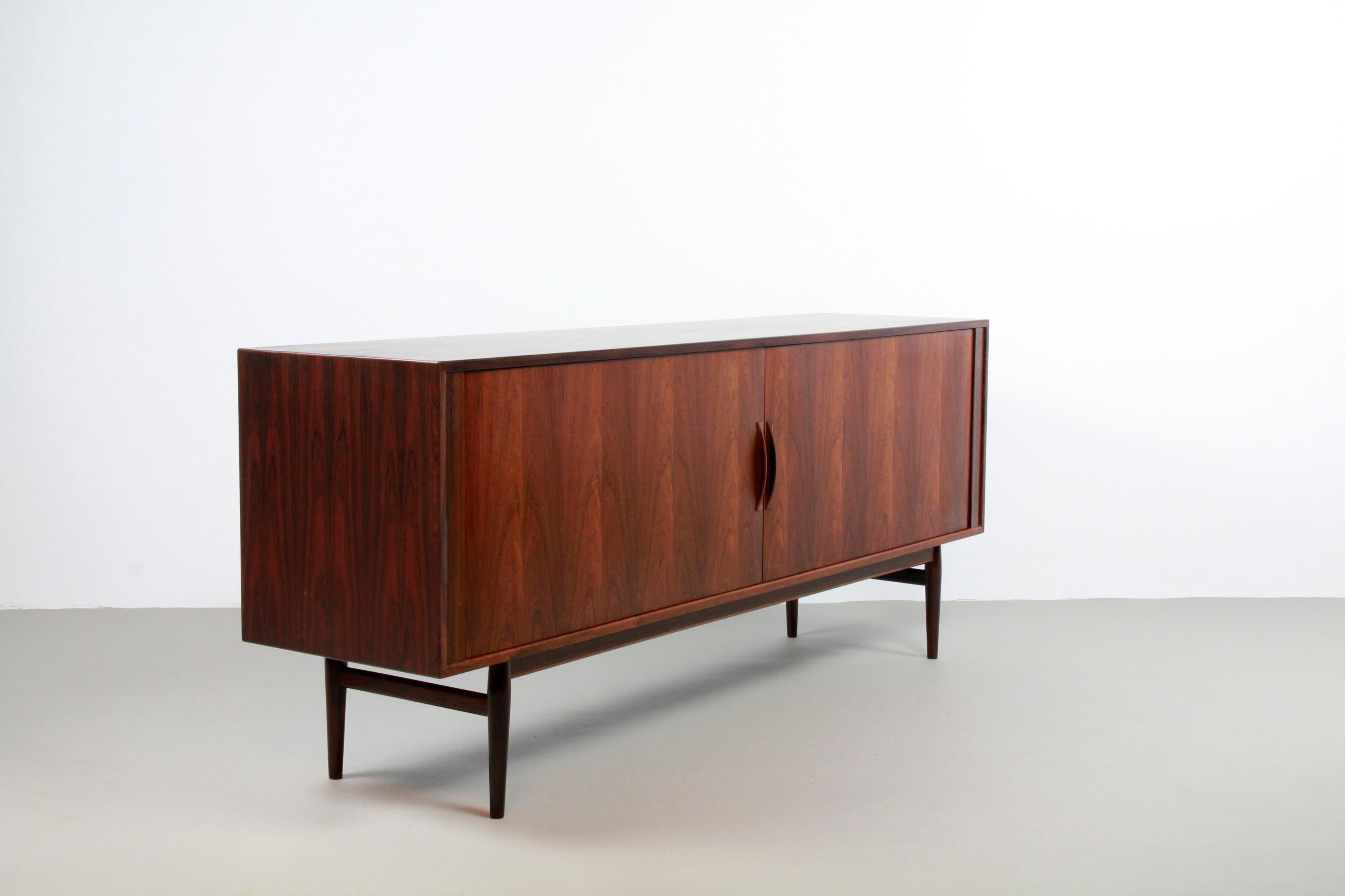 Particularly beautiful sideboard, Model 37, designed by Danish designer Arne Vodder for Sibast, Denmark in the 60's. The sideboard is made of tropical hardwood and has a very nice pattern in the woodgrain. The sideboard has two 'tambour' sliding