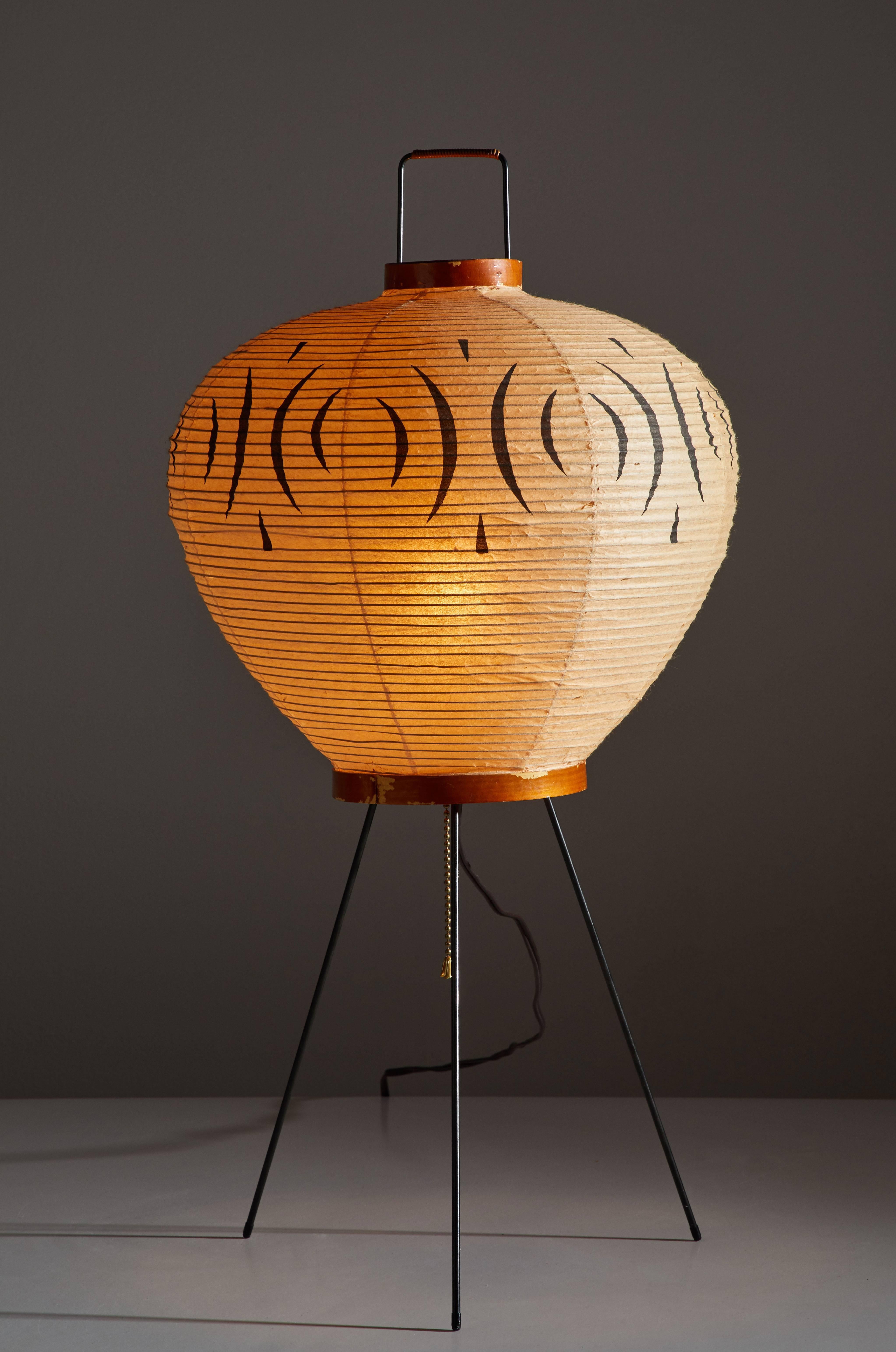Rare, original model 3A table lamp by Isamu Noguchi for Akari. Designed in Japan, early 1950s. Rice paper, wood and metal handle and legs. Retains the original sun, moon Noguchi stamp. Comes in the original Akari box. Original hand-painted design to