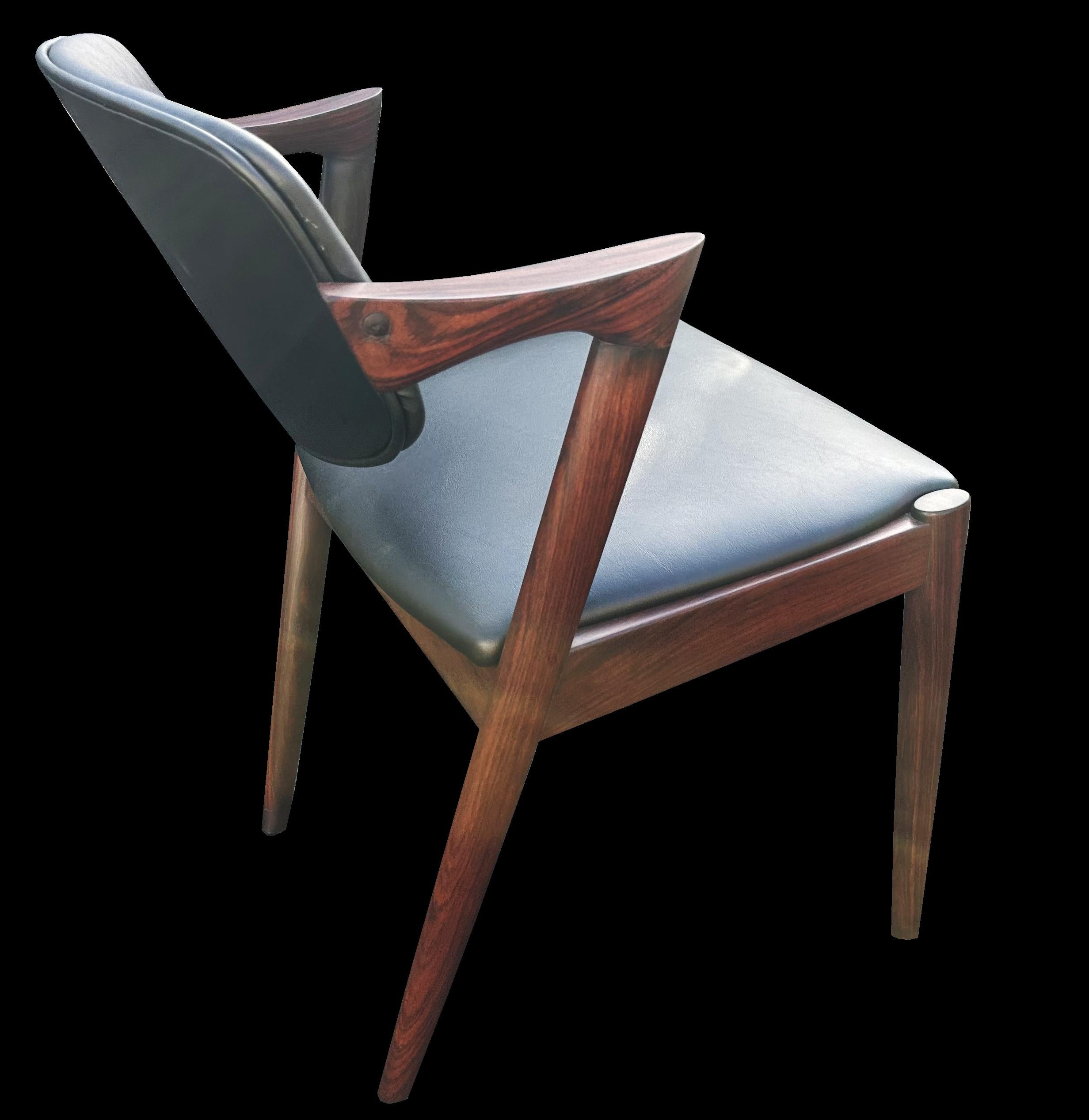 Priced individually, we have 14 of these model; 42 armchairs by Kai Kistiansen, all are very similar grain and colour, and all are freshly recovered in black leathercloth.
They are made from solid Santos Rosewood or Machaerium Scleroxylon, which is
