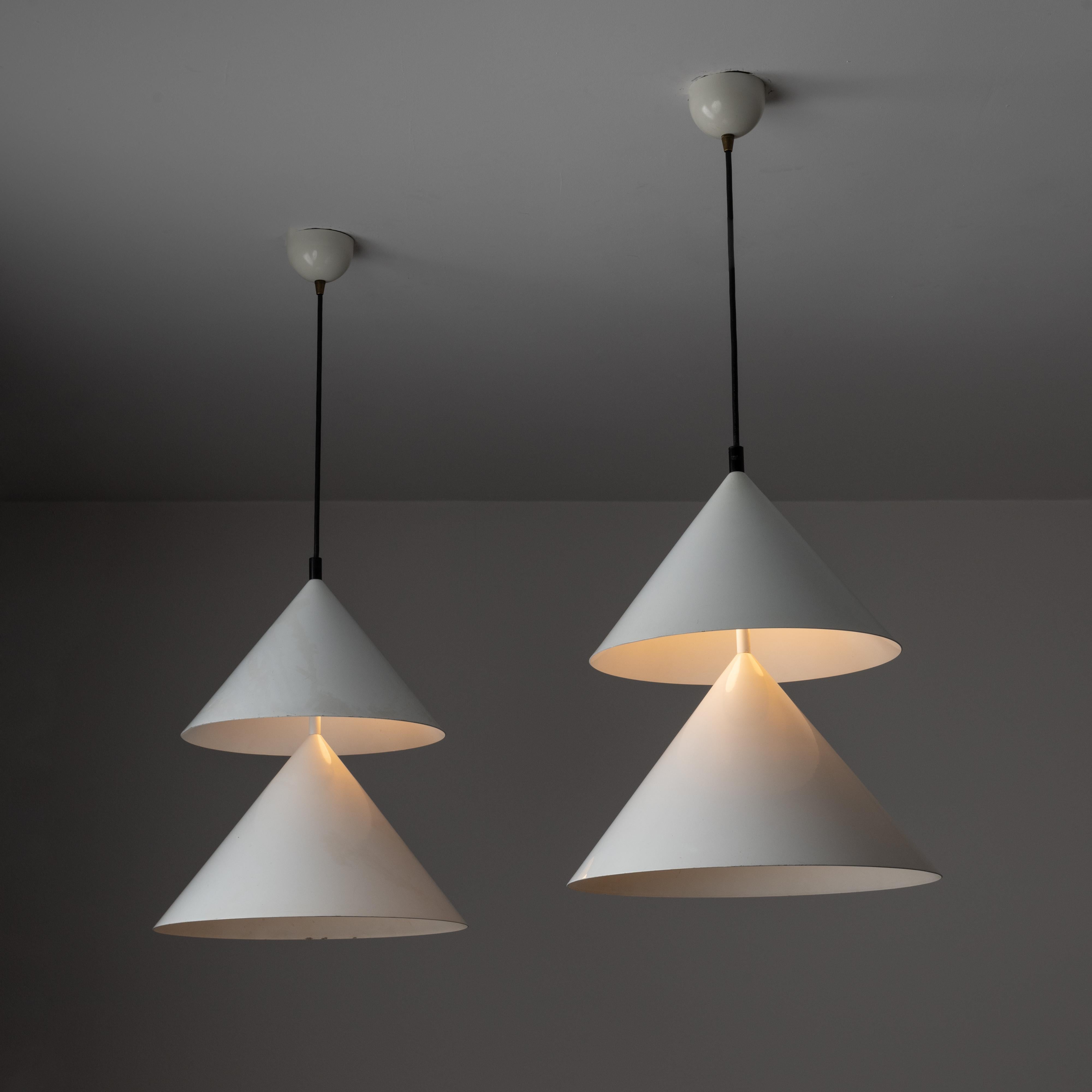 A pair of model 430 'Pascal' pendants by Vico Magistretti for Oluce. Designed and manufactured in Italy, in 1979. Minimalistic double-coned pendants show the turn of the decade from mid-century to post-modern design. The entire construction and