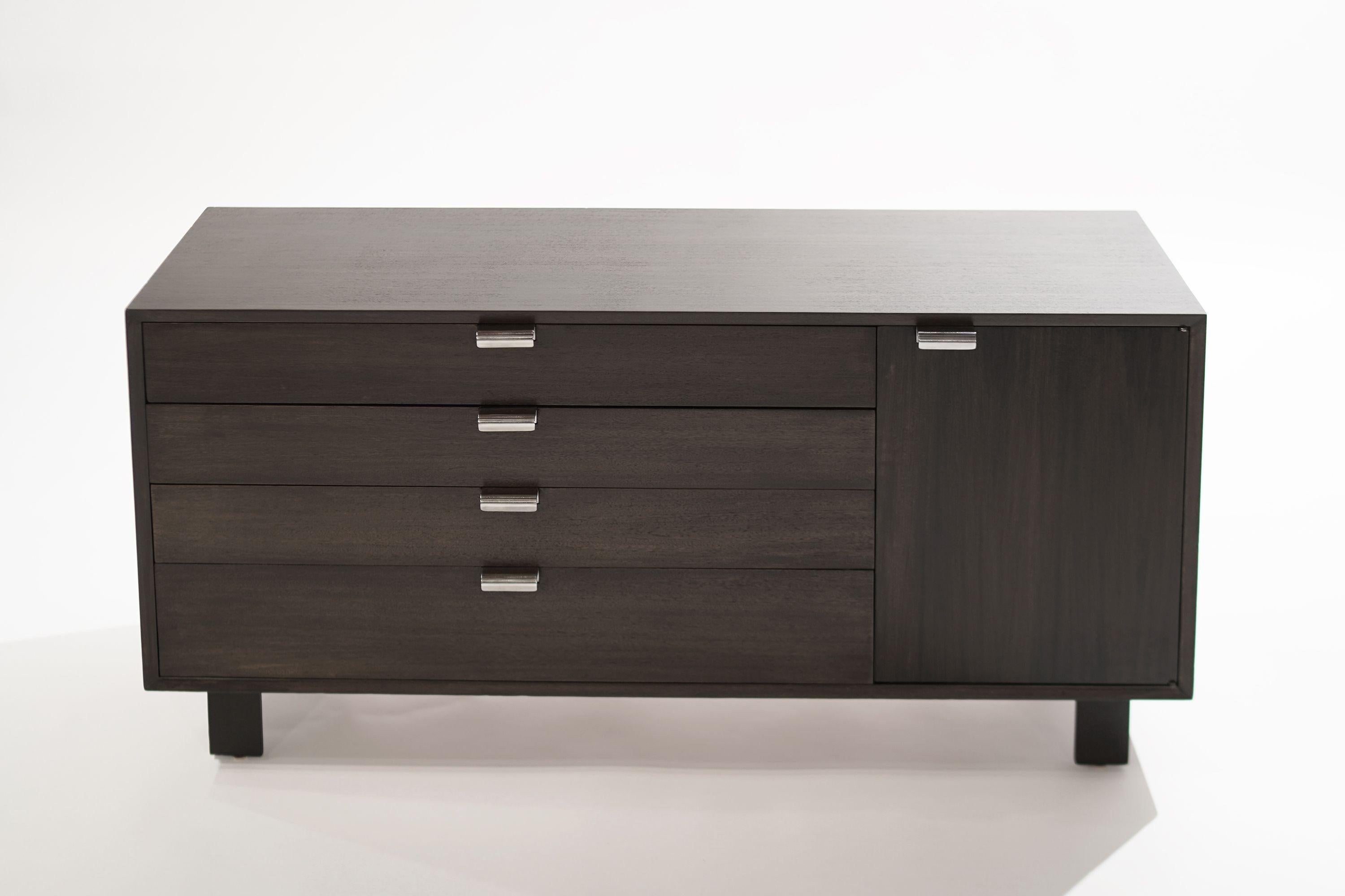 From Nelson's versatile line of case goods for Herman Miller, this model 4712 in mahogany from the Basic Cabinet Group features four drawers, the bottom one being larger. The door opens up to reveal dual adjustable shelves. Nickel hardware newly