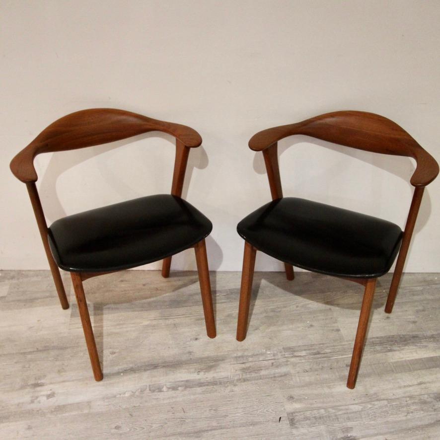 Great set of Kirkegaard-designed teak armchairs from the 1950s. Newly refinished with clean black leather seats. 
Erik Kirkegaard is mostly known for his minimalistic chair designs. One of his more dominant and recognizable design features was the