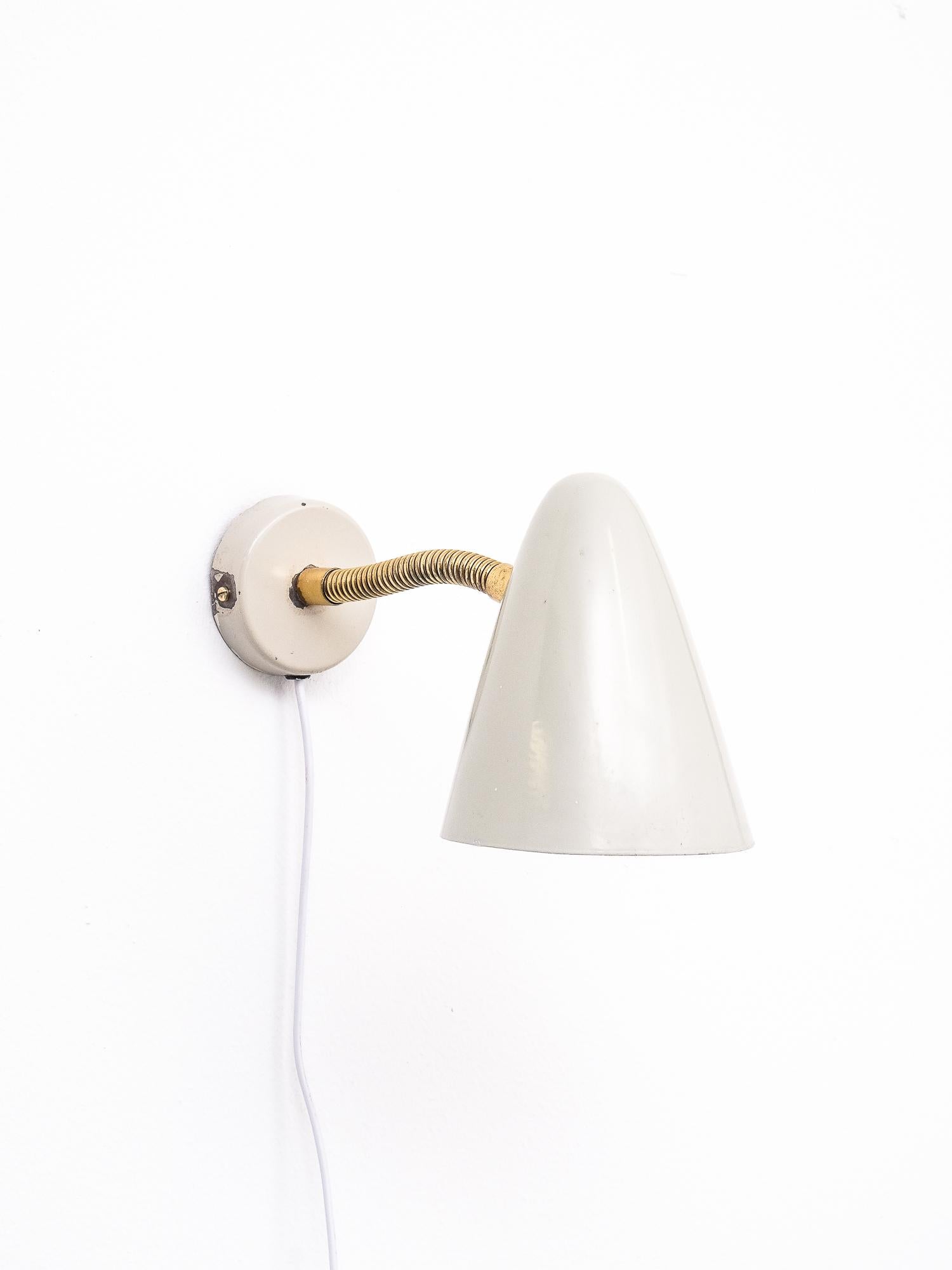 1950s Lisa Johansson-Pape model 50-084 wall light for Orno, Finland.

Adjustable wall light with brass gooseneck arm. Shade can be raised and lowered as well as rotated right and left.

Measures: Shade diameter 13 cm
E27 bulb holder.