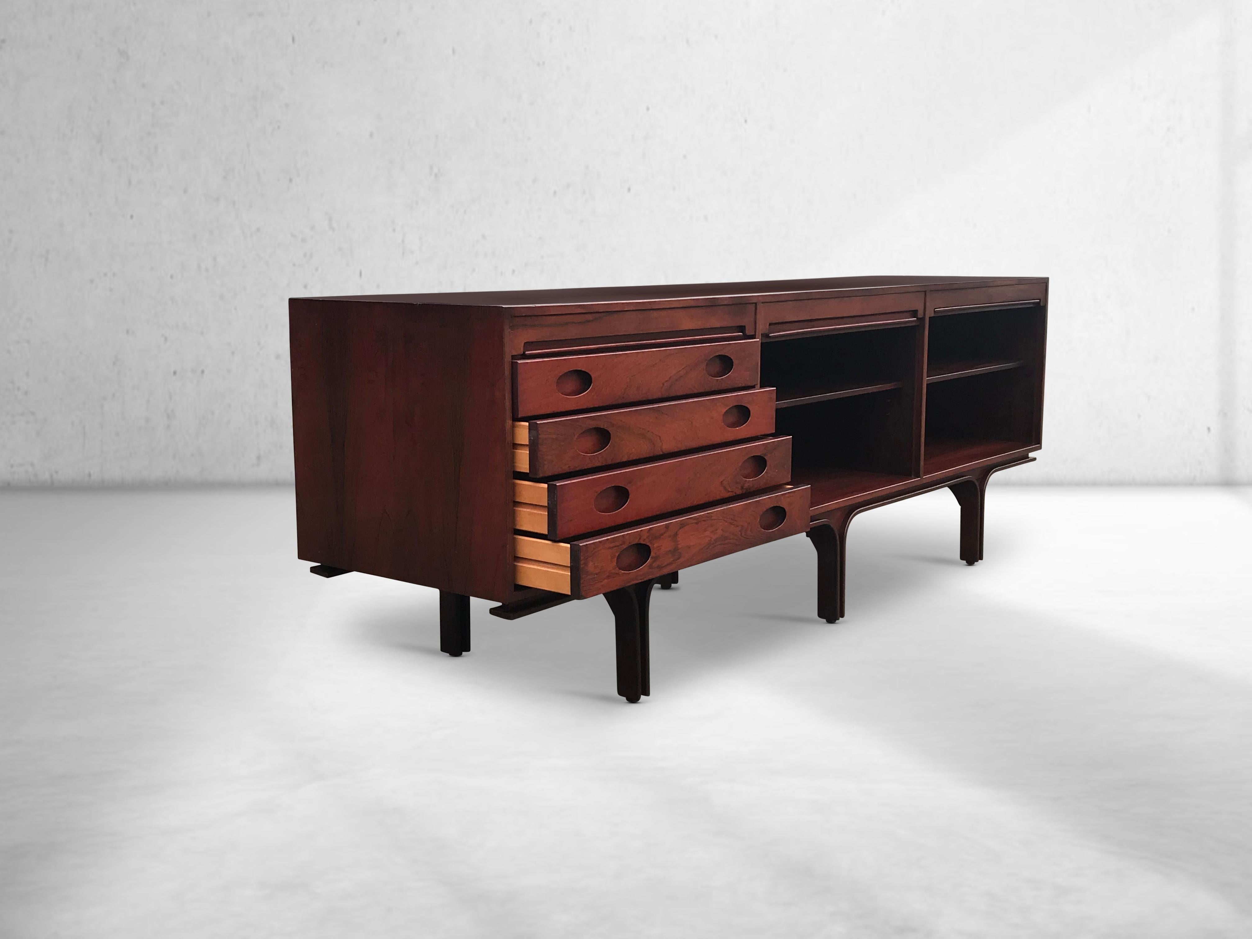Long Italian sideboard with roll doors. The piece was designed by Gianfranco Frattini for Bernini. Manufactured and produced around 1960s with highest care for detail and true craftsmanship. It features three storage sections, each one hidden behind