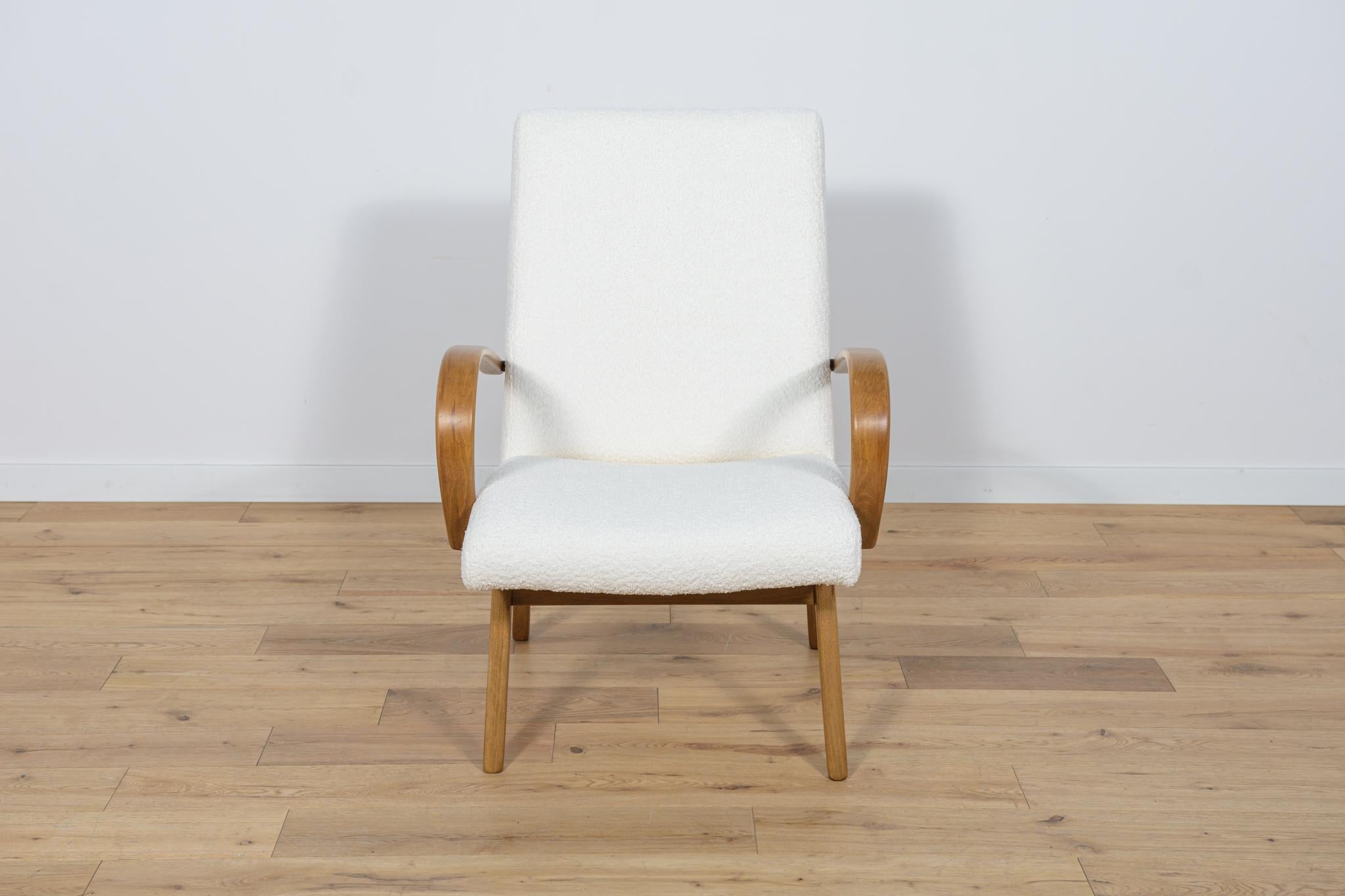 Model 53 armchair was manufactured by Ton in the 1950s to 1960s. They were designed by Jaroslav Smidek. The upholstery interior has been changed and covered with a high-quality white colored fabric typ boucle. The frame is in bent beech. The beech