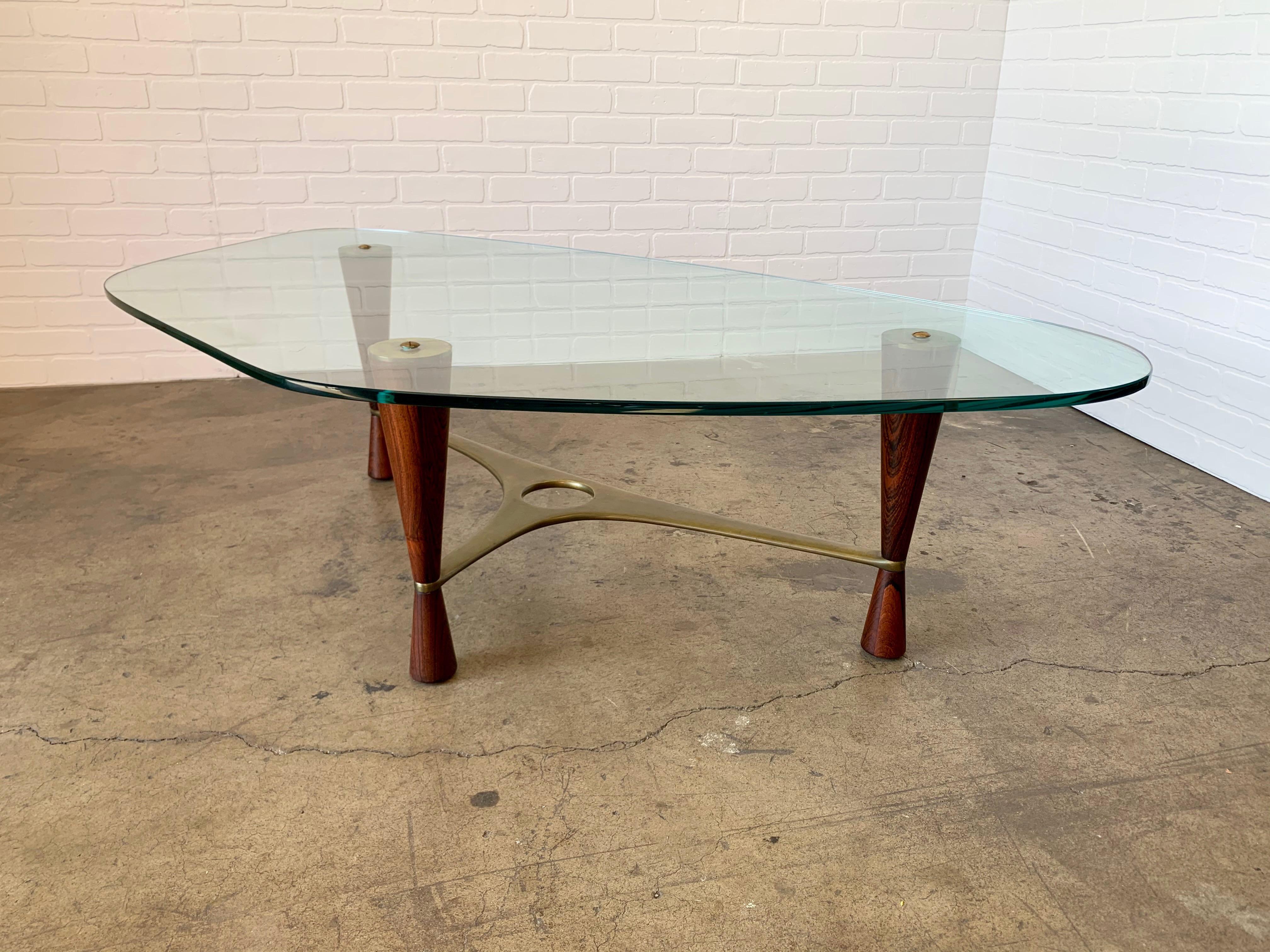 Model 5309 rare coffee table by Edward Wormley for Dunbar. Combination of rosewood and brass with the original glass top.