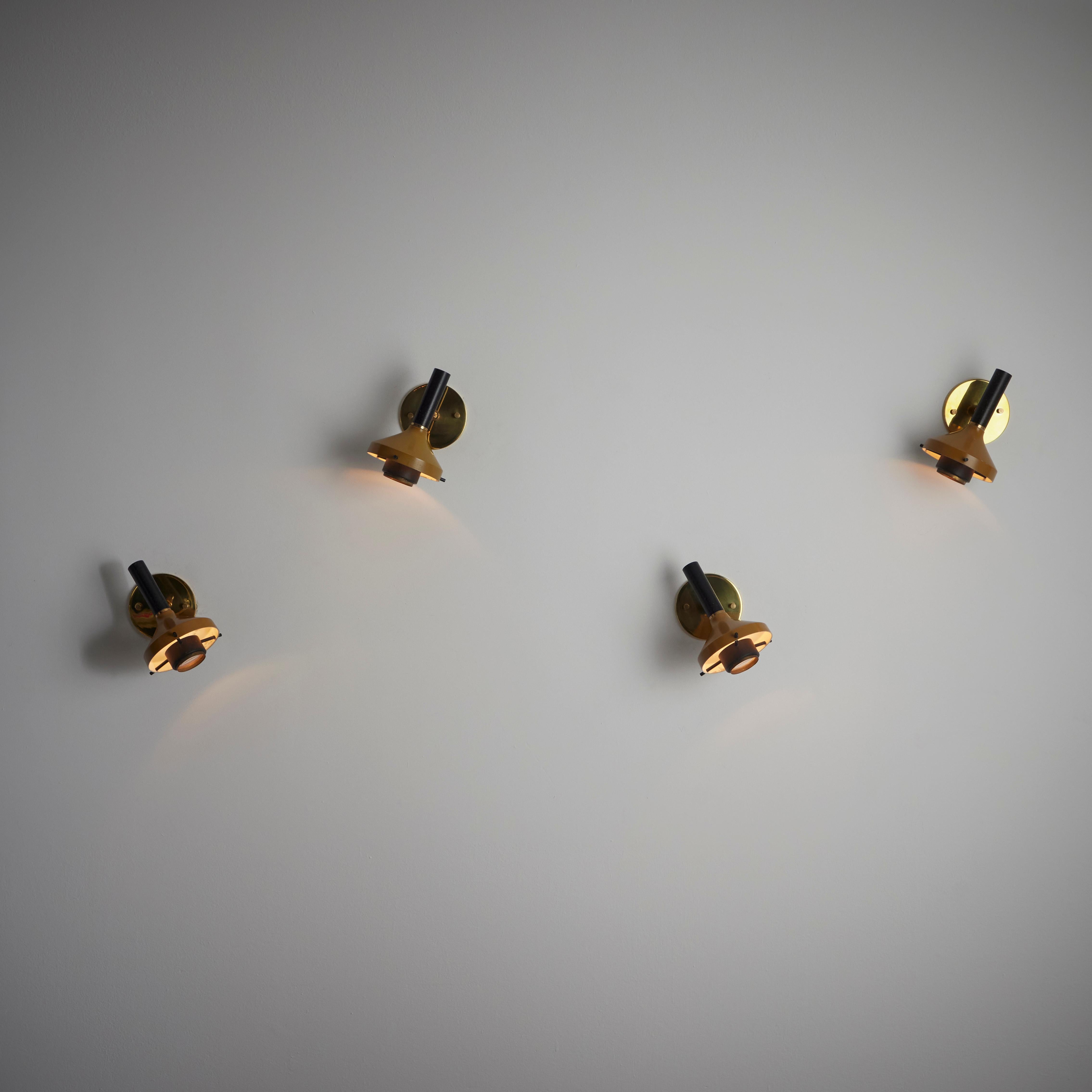 Model 533 Sconces by Oscar Torlasco for Lumi. Designed and manufactured in Italy, circa 1950. Wall sconces with a two-toned enameled exterior finish, consisting of a mustard and black color combination. Glass magnifier type diffuser finish these