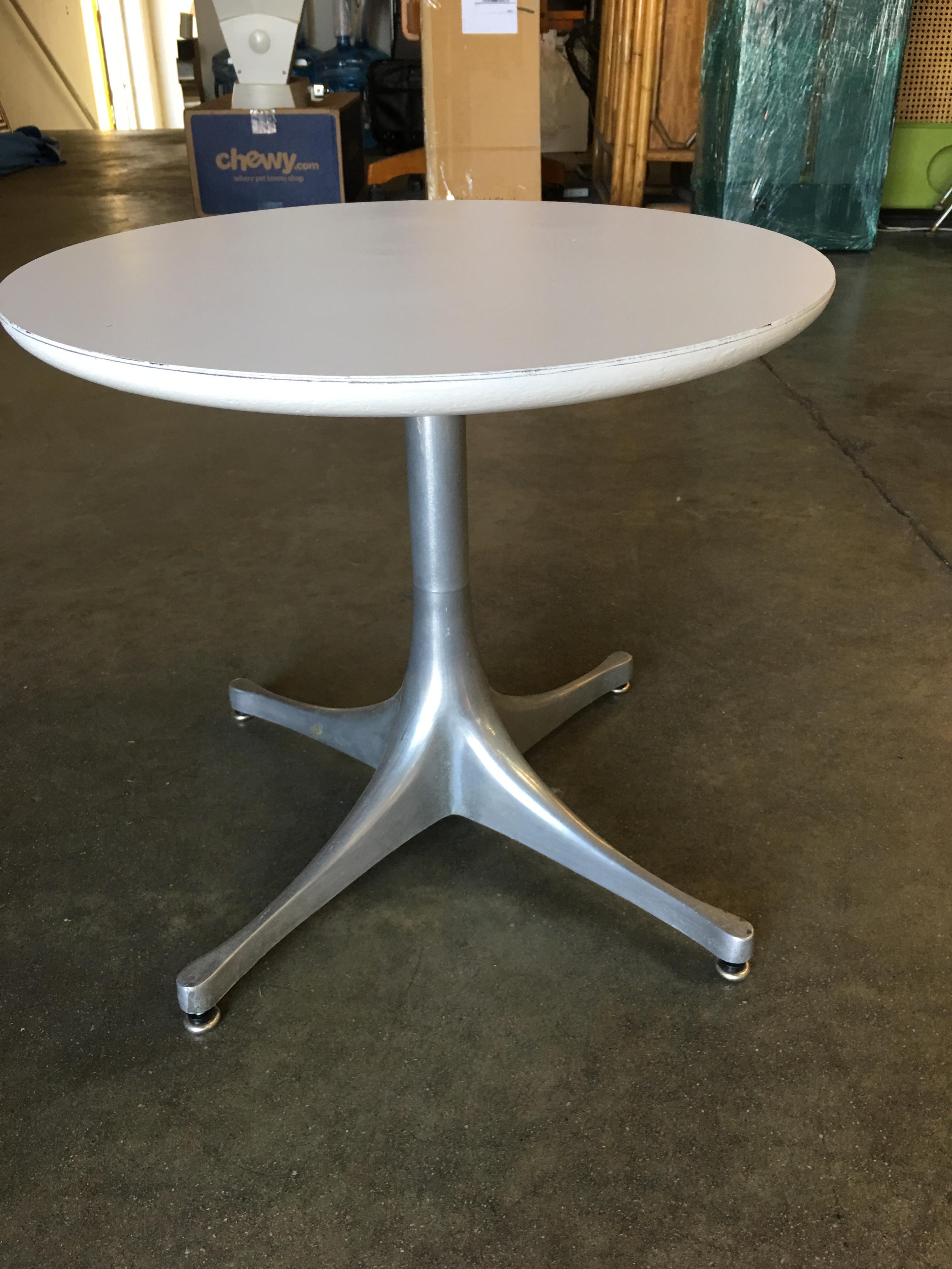 Model 5452 pedestal side table by George Nelson for Herman Miller featuring the iconic slopped top and root like 4 foot base.
