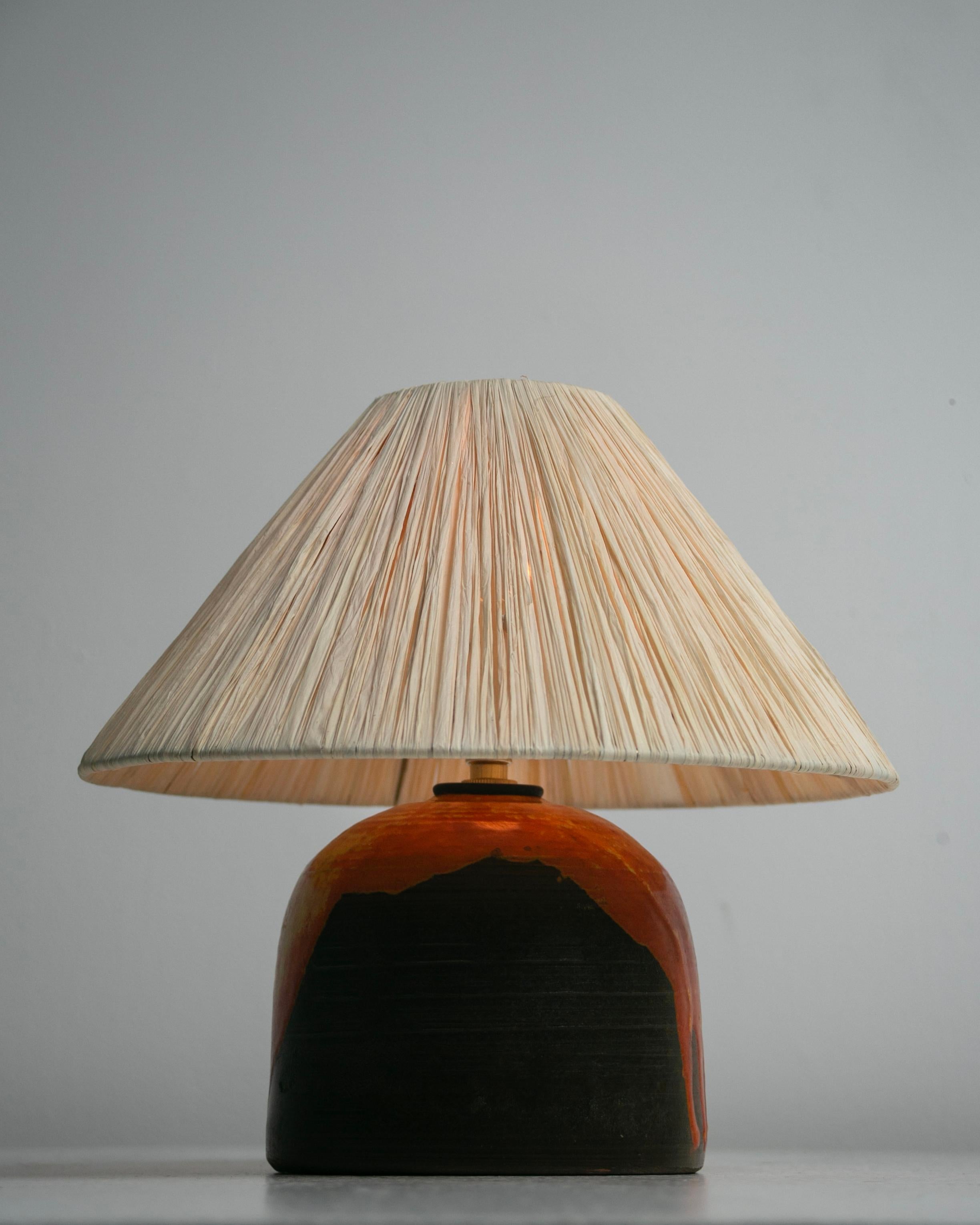 Table Lamp by Alessio Tasca, model 546. Designed and manufactured in Italy, circa the 1970s. Abstractly painted ceramic table lamp with a raffia shade (newly fabricated). The lamp holds a single E14 socket, adapted for the US. We recommend a single